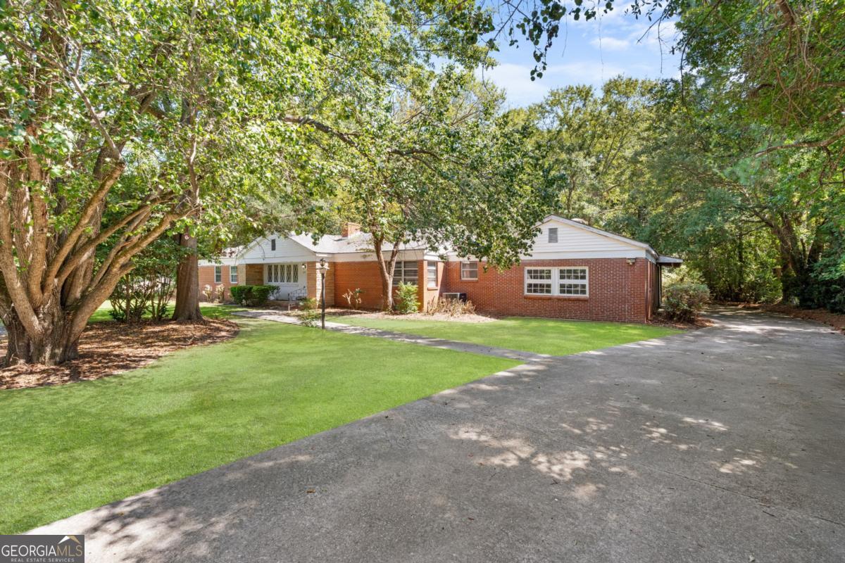 Welcome to this beautifully maintained 4-bedroom, 2,184 sq ft all-brick home nestled on a .76 acre lot in Edgewood Acres neighborhood. Featuring classic curb appeal and solid construction, this home offers comfort, space, and functionality for modern living. Inside, youll find a spacious living area complete with a cozy fireplace-perfect for relaxing or entertaining guests. The large kitchen is a cook's dream, boasting ample cabinetry and generous countertop space, making meal prep a breeze. All four bedrooms are generously sized, offering flexibility for a home office, guest room etc. The spacious garage provides plenty of room for vehicles, storage, or a workshop setup. Dont miss your chance to own this timeless home in a well-established community.