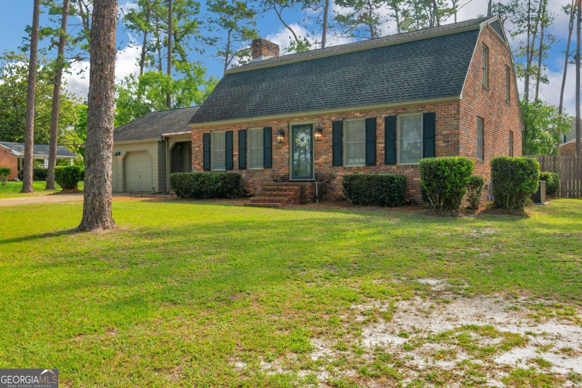 Welcome to this beautifully maintained 4-bedroom, 3-bathroom Dutch Colonial style home located in the highly desirable Cherokee Heights neighborhood of Waycross, GA. Combining timeless historic charm with modern updates, this spacious residence offers the perfect blend of style and functionality. Step inside to find a neutral color scheme that complements the home's character-rich details, including brick accents, pecky cypress walls in the den, and hardwood floors that add warmth and personality. With two inviting living spaces, there's plenty of room to relax, entertain, or use for a home office. The formal dining room is perfect for hosting gatherings, while the well-appointed kitchen and ample storage throughout the home ensure everyday convenience. Each of the four bedrooms offers generous space, and the three full bathrooms are thoughtfully updated for today's lifestyle. Outside, enjoy privacy and serenity in the large, fenced backyard-ideal for peaceful evenings under the stars. The home has been thoughtfully updated with a new HVAC for the upstairs, privacy fence, new hot water heater, new dishwasher and cooktop, new toilets in all baths, blown in insulation in the attic, and a new garage door system. Don't miss this rare opportunity to own a piece of Waycross history with all the comforts of modern living with a home that has been well cared for. Schedule your private showing today!