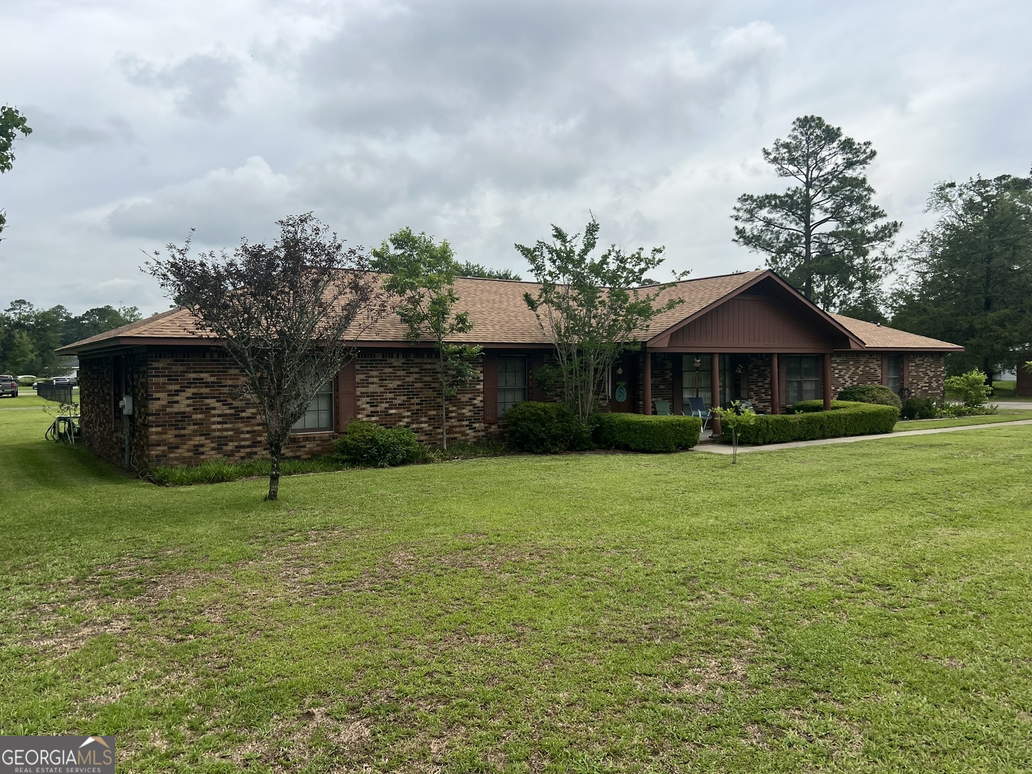 This well maintained 3 bedroom, 2 bath brick home has only had 1 owner! Custom built in 1979 with 2100 square feet heated and situated on a beautiful 0.65 acre lot in the established Wayne Terrace Subdivision. The roomy kitchen has lots of cabinet space, stainless appliances, and views of the front and back yards! If extra space is what you're looking for than this is a must see with the living room on off the foyer at the front of the house and a nice den with fireplace and doorway leading to the back patio. Other exterior features include a new roof in 2025, irrigation system on shallow well, AND a spacious 24x24 detached shop/garage with electricity and work benches! This home has been well loved and ready to pass on to another loving owner!