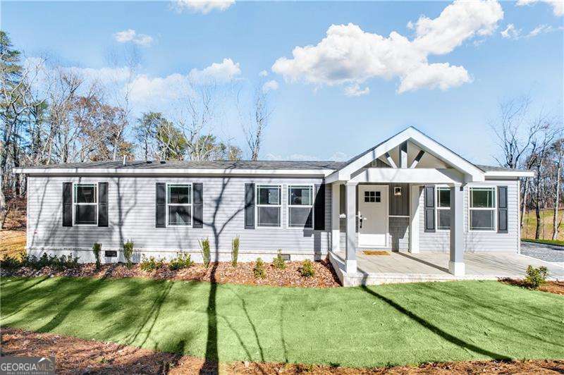 Back on the market through no fault of the seller. This home is USDA Loan Qualified -No money down. Charming Modern Home on 1.54 Acres with No HOA - Built for Comfort and Durability Welcome to 350 Pea Ridge Road - a beautifully updated 3-bedroom, 2-bath home nestled on a spacious 1.54-acre lot in the scenic foothills of Ball Ground, GA. Thoughtfully designed for both comfort and resilience, this 1,568 sq. ft. home is permanently affixed to an 8-inch concrete slab foundation and features hurricane-resistant construction for lasting peace of mind. Step inside to discover a bright and open floor plan filled with tasteful upgrades. The kitchen boasts stainless steel appliances, a stylish farmhouse sink, and modern cabinetry-perfect for everyday living and entertaining. Crown molding, ceiling fans, and premium finishes throughout add a touch of sophistication, while the expansive front and back decks offer ideal spaces to relax and enjoy the surrounding natural beauty. With no HOA restrictions, you'll have the freedom to truly make this property your own. It's located just minutes from Foothills Shopping Center, I-575/515, local dining, and outdoor recreation-combining rural tranquility with everyday convenience. Classified as real property and built on a permanent foundation, this home provides the value and stability of a traditional site-built home, making it a smart investment for today and tomorrow. Don't miss this opportunity to own a turnkey home in a desirable location-schedule your private tour today!