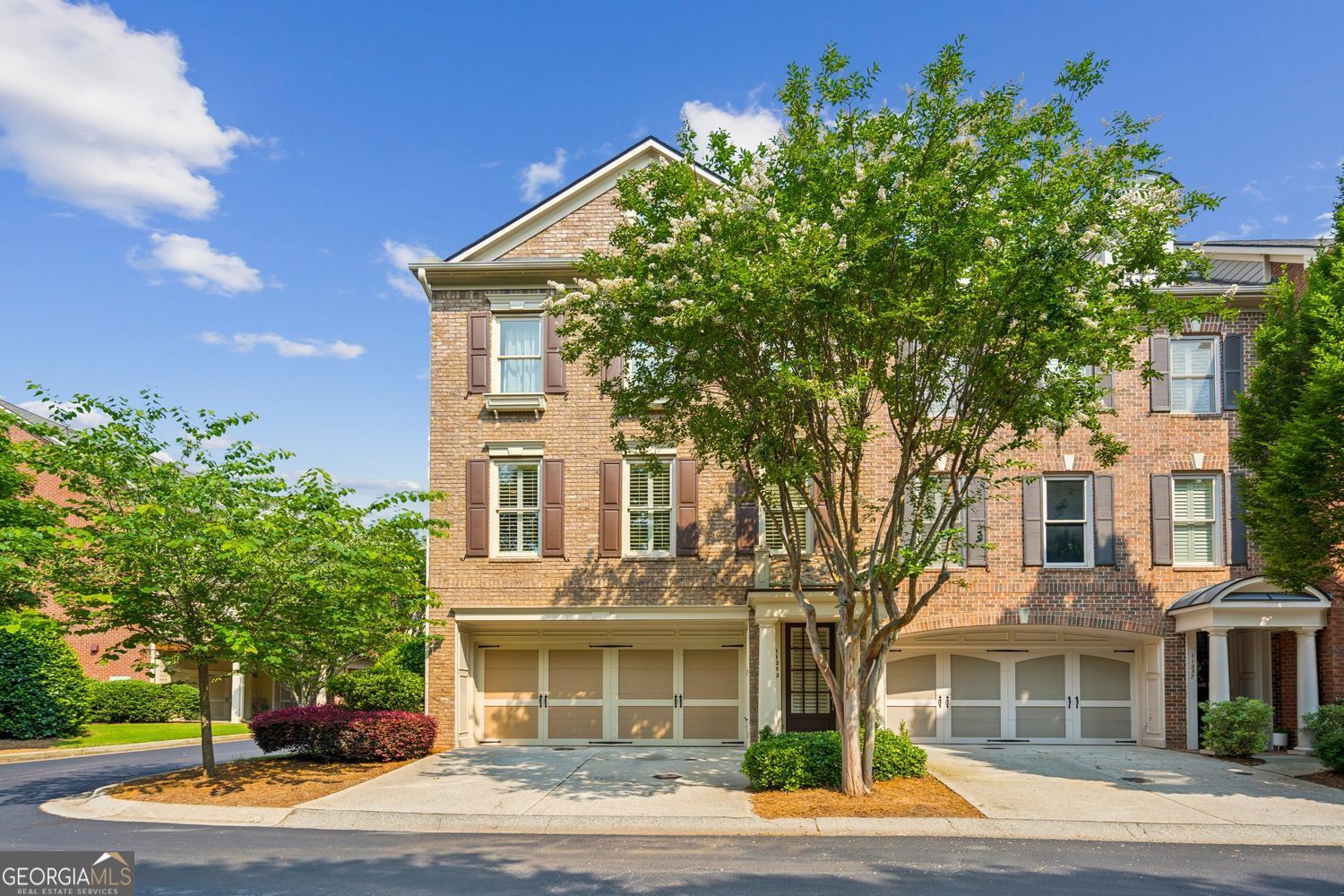 Rarely available end-unit townhome offering the space and comfort of a single-family home.This light-filled home features a 2-car garage with Tesla charger, an open concept design, large kitchen, and expansive picture windows. Enjoy private and unobstructed views and light from every window and the convenience of a lock-and-go lifestyle.The well-planned layout includes a generous kitchen with a central island, gas cooktop, oversized pantry, and abundant cabinetry - a true hub for gathering and entertaining. The versatile terrace level provides the perfect flex space for a guest suite, media room, or home office. Well-situated in the community's, this home offers convenient guest parking and close proximity to the pool, fitness center, and clubhouse. Beyond the neighborhood, you're minutes from GA-400 and within walking distance of top destinations including the Amphitheater, North Point Mall redevelopment, The Gathering, and the future Alpha Loop connection...unlimited access to Alpharetta's most exciting growth corridor.