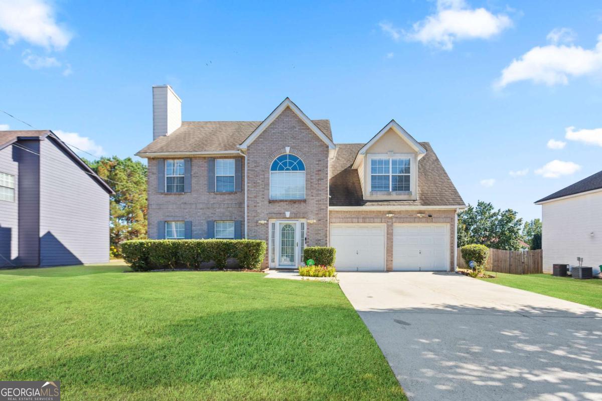 Prime location off Wesley Chapel Rd of I-20. Few minutes away from grocery, restaurants, shops and highway access. NO HOA! HVAC systems replaced in March 2025. SOLD in AS-IS condition. Brick front with cement board siding on a Leveled Lot, Two story foyer, cozy family room with fireplace that opens to the dining room. Spacious kitchen and a large breakfast area next to the laundry room. Upstairs: Master suite with tray ceiling, walk in closet, double vanity, separate tub and shower. One oversized secondary bedroom with high ceiling above the garage with multi-use function, Another secondary bedroom with tray ceiling and a hallway access full bath.