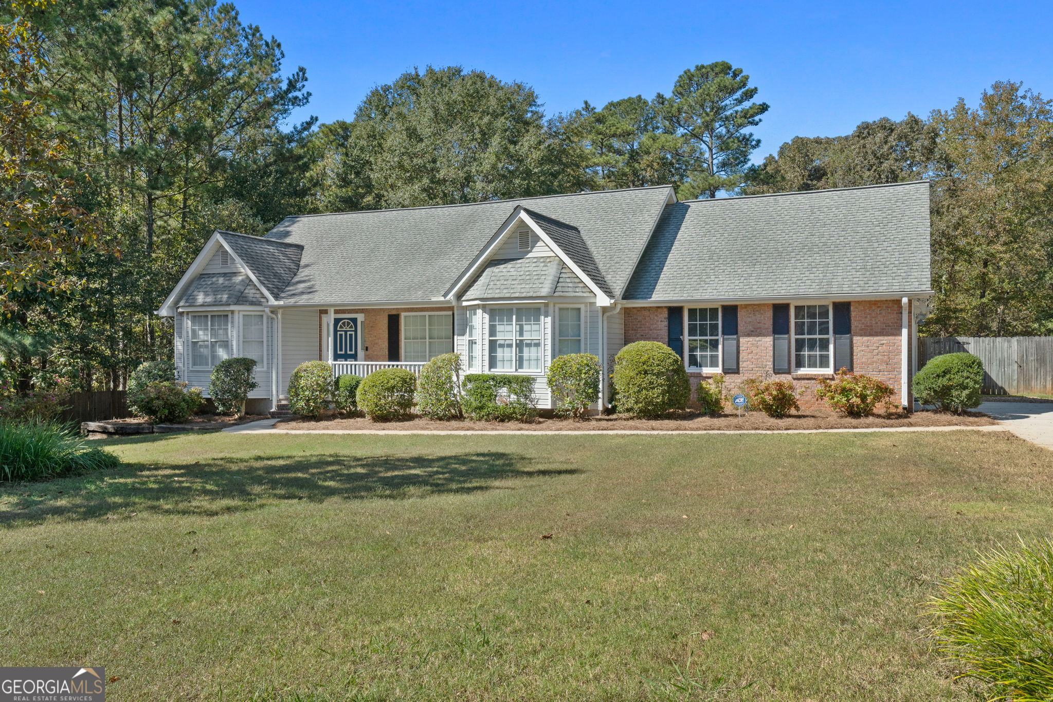 Don't miss this opportunity to purchase a value-packed property at a very attractive price point in McDonough! This brick-front ranch is situated on an approximately 3.11 acre cul-de-sac double lot in the quaint Orleans Place neighborhood. Inside you'll find a split-bedroom plan with 3 bedrooms and 2 bathrooms. Foyer entry with hardwood floor. Formal dining room with tray ceiling. Don't ever use a dining room? It would make an awesome den, office or playroom! Living room includes a vaulted ceiling and gas starter fireplace, and overlooks rear deck. Kitchen with tile backsplash, wall-to-wall cabinetry, gas range and stainless steel dishwasher. Bay window breakfast area. Large laundry room with pantry for kitchen essentials. Primary bedroom with tray ceiling, walk-in closet and its own private door to the rear deck. Primary bathroom with double sink vanity, soaking tub and separate shower. Newer HVAC and water heater. Outside you'll find a well-manicured yard dappled with apple and pear fruit trees. Gated access to backyard. Need a place to park the RV or boat? You'll love the approximately 24x50 RV shed with 14-foot sides! It even has existing conduit in place for electrical service. If you need a workshop or just extra storage space, the +/- 28x20 outbuilding is a perfect spot! This property has been well cared for and it shows. And it's close to everything! Easy access to Highway 20/81 and I-75. Just a stone's throw to shopping and dining at the South Point retail development, Lowe's, Walmart and BJ's wholesale club.