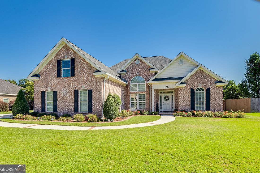 Immaculate & Move-In Ready! This all-brick home offers timeless curb appeal with a wide, paver-framed driveway and convenient side-entry garage. Step inside to a spacious living room with cozy fireplace, a formal dining room, and plantation shutters in the main living area. The kitchen features abundant cabinetry, Corian countertops, and stainless steel appliances. The owner's suite is on the main level, complete with a spa-style bath boasting double vanities, a separate shower, soaking tub, and large walk-in closet. Two additional bedrooms and a full hall bath are also on the main level, with a fourth bedroom upstairs and plenty of walk in attic storage. Outside, enjoy a private backyard with ample room for a garden, enclosed with a privacy fence. Behind the fence , a pond for additional privacy. Don't miss the chance to make this immaculate property your new home-schedule your private showing today!
