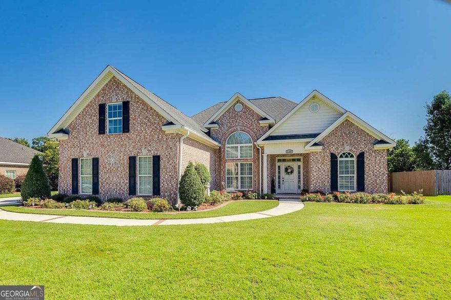 Immaculate & Move-In Ready!  This all-brick home offers timeless curb appeal with a wide, paver-framed driveway and convenient side-entry garage. Step inside to a spacious living room with cozy fireplace, a formal dining room, and plantation shutters in the main living area. The kitchen features abundant cabinetry, Corian countertops, and stainless steel appliances.  The owner's suite is on the main level, complete with a spa-style bath boasting double vanities, a separate shower, soaking tub, and large walk-in closet. Two additional bedrooms and a full hall bath are also on the main level, with a fourth bedroom upstairs and plenty of walk in attic storage.    Outside, enjoy a private backyard with ample room for a garden, enclosed with a privacy fence. Behind the fence , a pond for additional privacy.  Don't miss the chance to make this immaculate property your new home-schedule your private showing today!