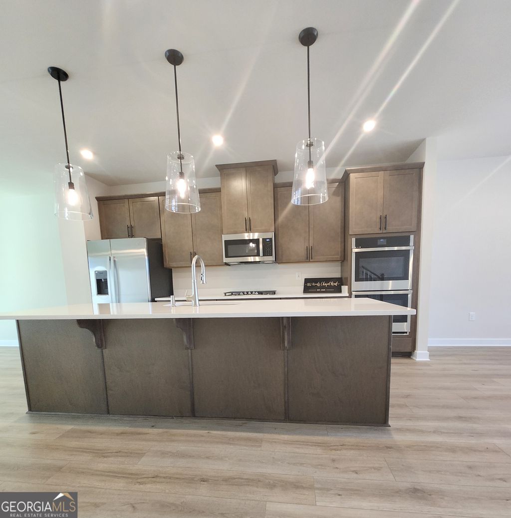 Photo of 852 Woods Chapel Rd, Sugar Hill, GA 30518 (MLS # 10681406)