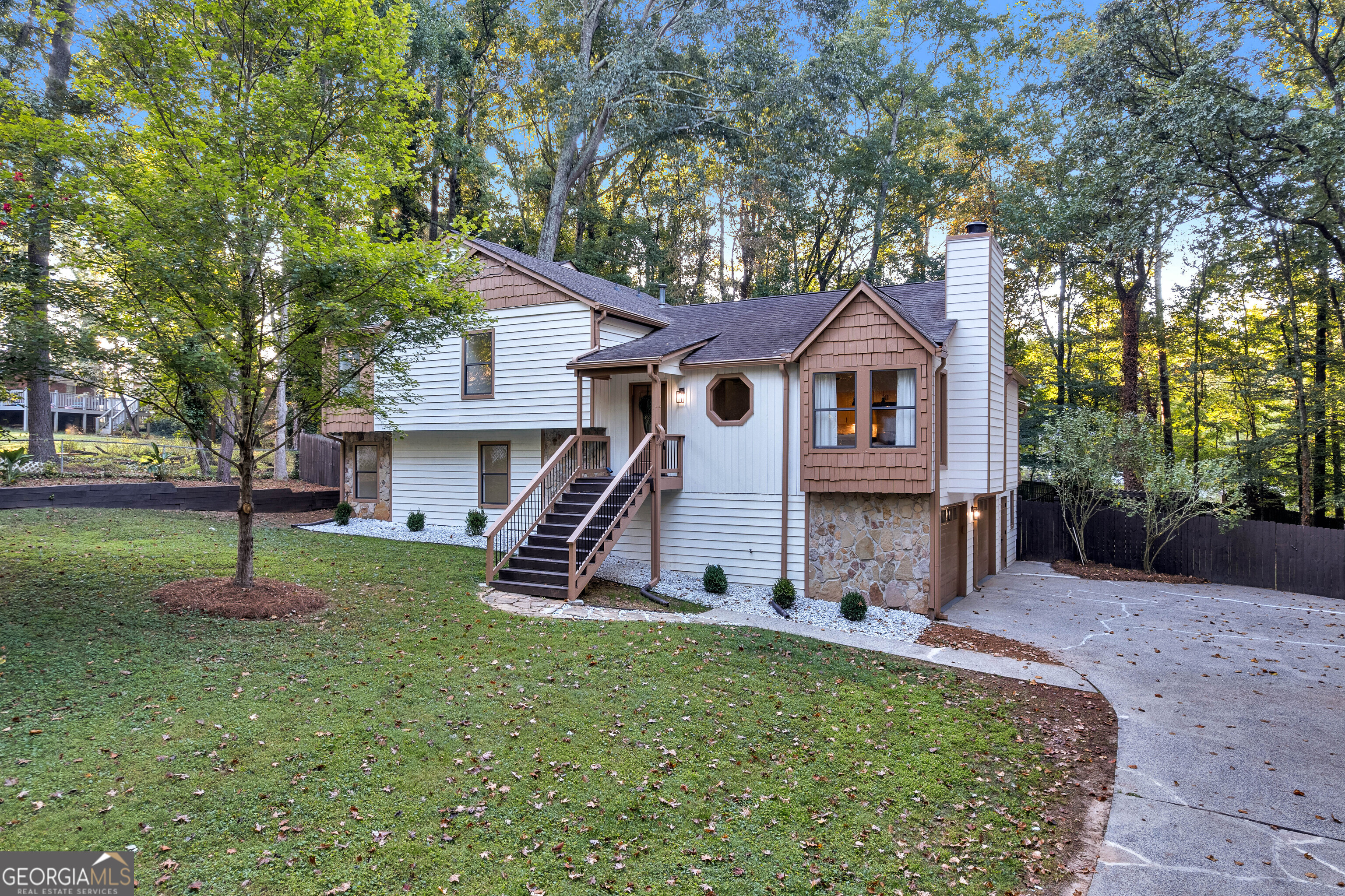 Discover comfort, space, and community living in this beautifully updated 4-bedroom, 3-bath home, plus multiple bonus romos, nestled in the quiet, established Sherman Ridge neighborhood of West Marietta. Set on a rare 1.27-acre lot, this property offers privacy, room to grow, and a true connection to nature without sacrificing convenience. Zoned for top-rated Cobb County schools, Still Elementary, Lovinggood Middle, and the highly sought-after Hillgrove High School, it's perfect for families who value excellent education in a serene setting. Enjoy everyday ease with quick access to shopping, dining, and essentials, and spend weekends exploring Laurel Park, Kennesaw Mountain National Battlefield Park, or the charm of Downtown Marietta just 15 minutes away. Inside, you'll find new flooring, fresh interior and exterior paint, quartz countertops, and new appliances throughout. The flexible split-level layout features spacious living areas, a cozy fireplace, and multiple bonus spaces including a sunroom and family room. Outdoors, the expansive fully fenced backyard is ideal for entertaining, pets, or play, and includes a large deck, side porch, dedicated workshop, and oversized shed, perfect for storage, hobbies, or creative projects. A two-car side-entry garage, level driveway, and ample parking complete this move-in ready home. Don't miss your chance to own this updated home with acreage, privacy, and room to breathe, schedule your private tour today!