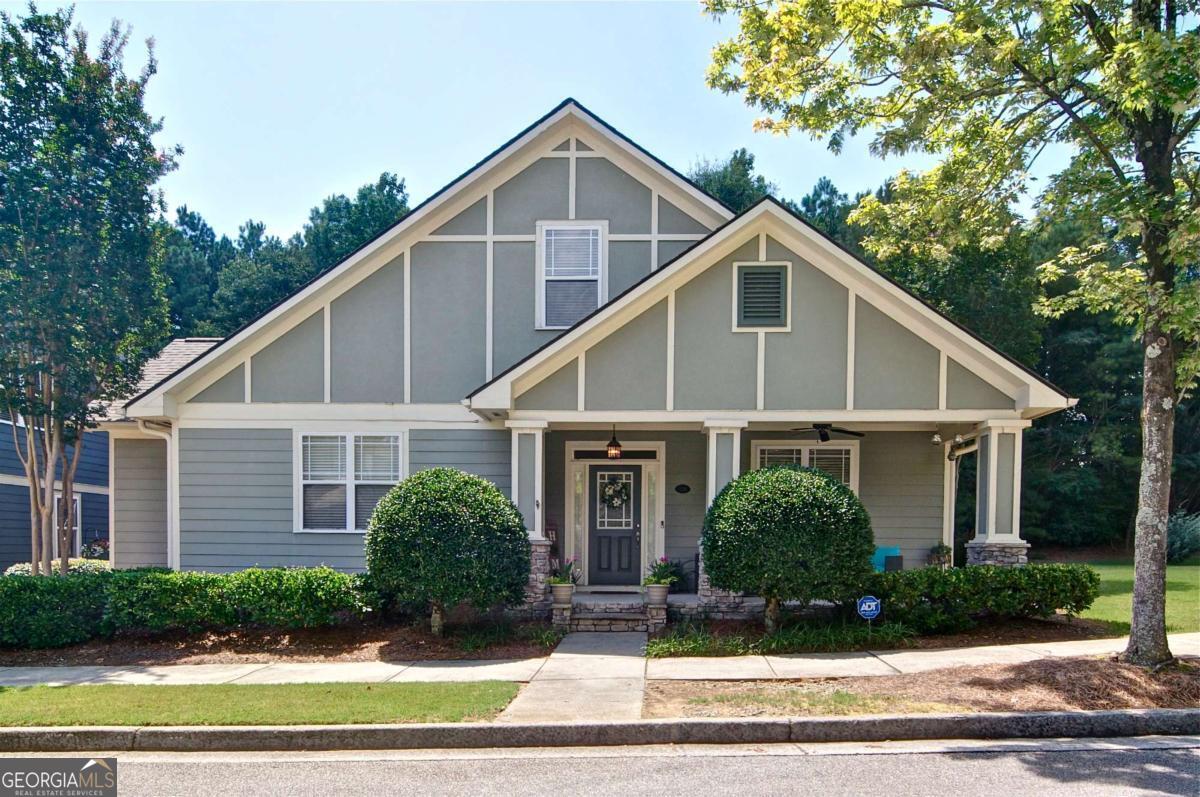 Welcome Home to your beautiful move-in ready Ivey Parc craftsmen! Fresh interior paint and carpet, new HVAC and 4 year old roof. The kitchen features hardwoods, stainless steel appliances and plenty of natural light. Attractive trim details and stylish lighting/fans throughout the home. Enjoy this premium corner lot on the cozy front porch and private back patio oasis! Retreat to your primary suite on the main level with generous walk-in closet. Convenient to sought-after schools, shopping, and restaurants. Don't miss this great opportunity to live in the heart of Grayson!