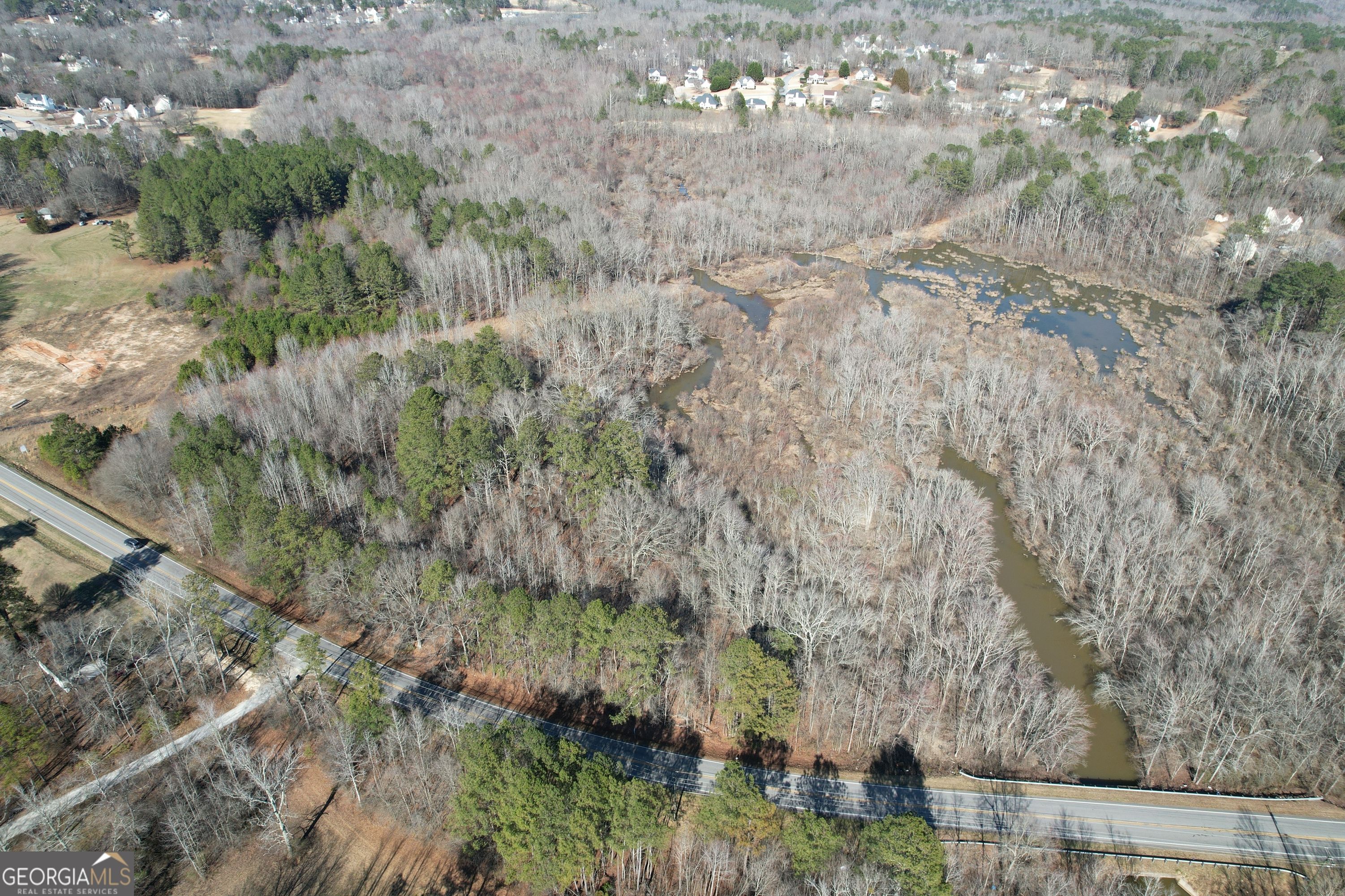 This incredible property boasts excellent homesites with frontage along the picturesque Lick Log Creek. Nestled amongst mature timber, the natural beauty of this area will take your breath away. This property offers over 750 ft of road frontage, providing easy access to your private oasis, and giving you the flexibility to choose the perfect location for your dream home, while being less than 5 minutes from Kroger, Ingles, and many other amenities. The presence of beaver ponds, and open grass areas add a touch of tranquility to the surroundings. With several acres available, you have ample space to create your desired living environment. Imagine the joy of hunting and fishing right in your own backyard. This property provides opportunities for hunting deer, small game, and waterfowl. The creek and beaver ponds provide the opportunity to fish and kayak. Experience the outdoors like never before without having to leave your property! Don't miss out on owning this remarkable real estate offering that combines an excellent homesite, creek frontage, mature timber, and abundant natural beauty.