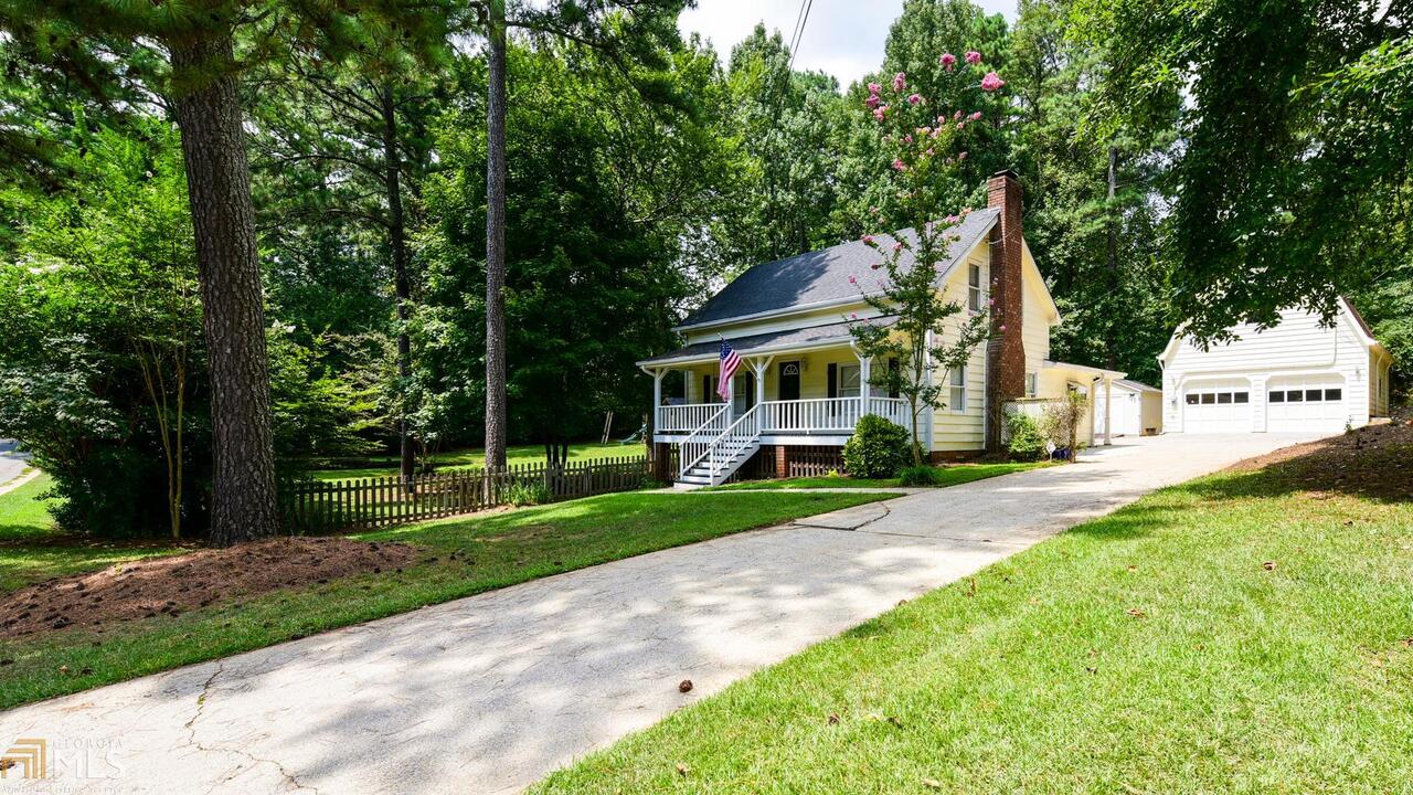 This is an amazing rocking chair front porch, picket fence, huge fenced lot, oversize workshop, beautiful Master suite, Chef's Kitchen, decks, patios, extended driveway, beautifully done with fresh paint, carpet, blinds, Bamboo floors, this house is so amazing! Southern Charm nestled near the Covered Bridge and Silver Comet Trail