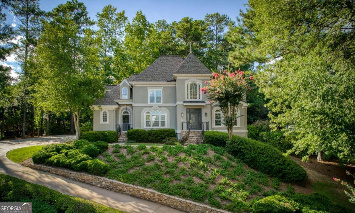 Welcome to Luxury Living in Gated St Ives Country Club located in Johns Creek - Top Rated Schools! This is the One You Have been Waiting For! Located on St Ives Main Parkway this Home sits up for Maximum Views and Privacy. Grand 2 Story Foyer Opens to Beautifully Paneled Library/Study w/Fireplace and Built-Ins. Large Dining Room Perfect for Large Dinners! Cozy Step Down Family Room Features Wall of Windows, Fireplace & Built-In Bookcases - Plus Double French Doors that Open to Private Patio. Bright, Sunny Kitchen Perfect for Cooking - Plenty of Counter Space and Double Ovens Plus Appliance Garage. Back Staircase between Kitchen & Family Room. Master on Main Features High Trey Ceiling & Master BA w/Sep Vanities and Large Walk-In Closet.  Upstairs is Incredible - Super Large Bedrooms w/Walk-In Closets! Terrace Level is Awesome! Huge Open Greatroom w/Fireplace plus Pool/Table Game Room. Owner Currently uses Bedroom as an Art Studio. Tons of space for Storage as Well! You will be so surprised in the Spring and Summer - the Gardens and Flowers in this Home are Stunning! You will Love Living in this Beautiful Home!