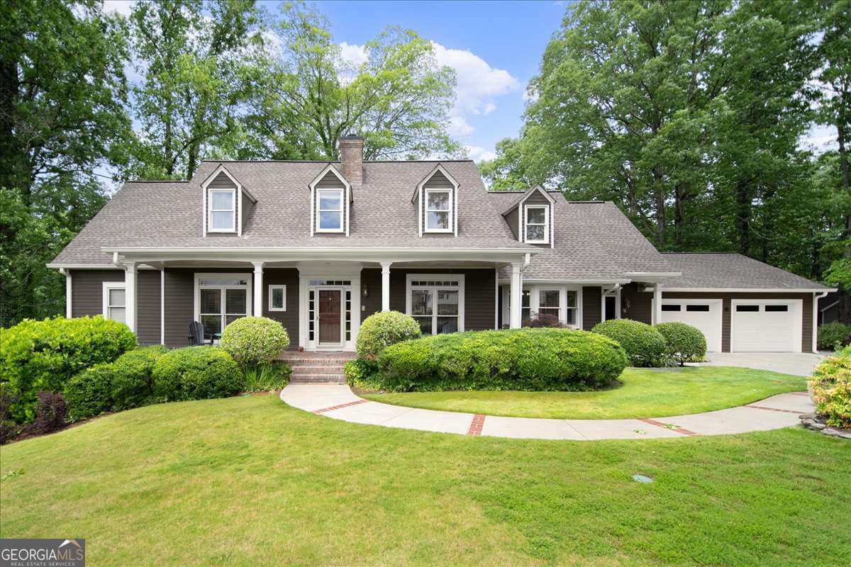 Location and privacy? Welcome to your own hidden haven in the heart of East Cobb, where every day feels like a peaceful secluded retreat, yet you are minutes to award winning Lassiter High School cluster, shopping, dining and all East Cobb has to offer. Set on 3 private, wooded acres looking out upon a peaceful pond, this 5 bed and 5 bath home is lovingly designed to blend timeless charm with everyday comfort. Step inside to witness a custom open-concept interior-no cookie cutter designs here- with a spacious family room that anchors the heart of the home. The fireside great room flows seamlessly into a newly renovated fresh white kitchen with quartz tops and backsplash, 2 sinks, double oven, induction cooktop and stunning skylight. A cozy library/office is, flanked by antique doors imported from Europe and tucked off the great room. Picture-perfect views of the lush, park-like backyard can be seen from nearly every room. A screened porch just off the kitchen and great room invites you into a serene outdoor sanctuary. The main level also features the pristine primary suite nestled in its own private wing, featuring a beautifully renovated bathroom. The formal living and dining rooms are grand yet inviting, with French doors that open to the main living areas. A separate entrance next to the garage provides a warm, functional welcome for guests or extended family. Upstairs, you'll find oversized secondary bedrooms with multiple walk-in closets and individual charm. Both bathrooms upstairs have been fully renovated in 2025. A cozy loft area offers the perfect nook for reading, gaming, or play. Downstairs, the fully finished terrace level was renovated in 2022 and features its own entrance, bar area/kitchenette, bedroom, full bathroom, spacious living area, and a second laundry room-ideal as a guest suite, in-law apartment, or even a rental opportunity. The driveway includes extra parking for added convenience. The basement also offers ample storage solutions including finished and unfinished space. What's more? the backyard is a true sanctuary: winding paths, antique garden gate, custom shed, and even a hidden picnic spot-all designed to surprise and delight. This home offers ample space to grow, create, and connect-ready for its next family to make it their own.