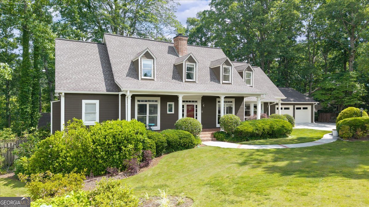 Location and privacy? Welcome to your own hidden haven in the heart of East Cobb, where every day feels like a peaceful secluded retreat, yet you are minutes to award winning Lassiter High School cluster, shopping, dining and all East Cobb has to offer. Set on 3 private, wooded acres looking out upon a peaceful pond, this 5 bed and 5 bath home is lovingly designed to blend timeless charm with everyday comfort. Step inside to witness a custom open-concept interior-no cookie cutter designs here- with a spacious family room that anchors the heart of the home. The fireside great room flows seamlessly into a newly renovated fresh white kitchen with quartz tops and backsplash, 2 sinks, double oven, induction cooktop and stunning skylight. A cozy library/office is, flanked by antique doors imported from Europe and tucked off the great room. Picture-perfect views of the lush, park-like backyard can be seen from nearly every room. A screened porch just off the kitchen and great room invites you into a serene outdoor sanctuary. The main level also features the pristine primary suite nestled in its own private wing, featuring a beautifully renovated bathroom. The formal living and dining rooms are grand yet inviting, with French doors that open to the main living areas. A separate entrance next to the garage provides a warm, functional welcome for guests or extended family. Upstairs, you'll find oversized secondary bedrooms with multiple walk-in closets and individual charm. Both bathrooms upstairs have been fully renovated in 2025. A cozy loft area offers the perfect nook for reading, gaming, or play. Downstairs, the fully finished terrace level was renovated in 2022 and features its own entrance, bar area/kitchenette, bedroom, full bathroom, spacious living area, and a second laundry room-ideal as a guest suite, in-law apartment, or even a rental opportunity. The driveway includes extra parking for added convenience. The basement also offers ample storage solutions including finished and unfinished space. What's more? the backyard is a true sanctuary: winding paths, antique garden gate, custom shed, and even a hidden picnic spot-all designed to surprise and delight. This home offers ample space to grow, create, and connect-ready for its next family to make it their own.