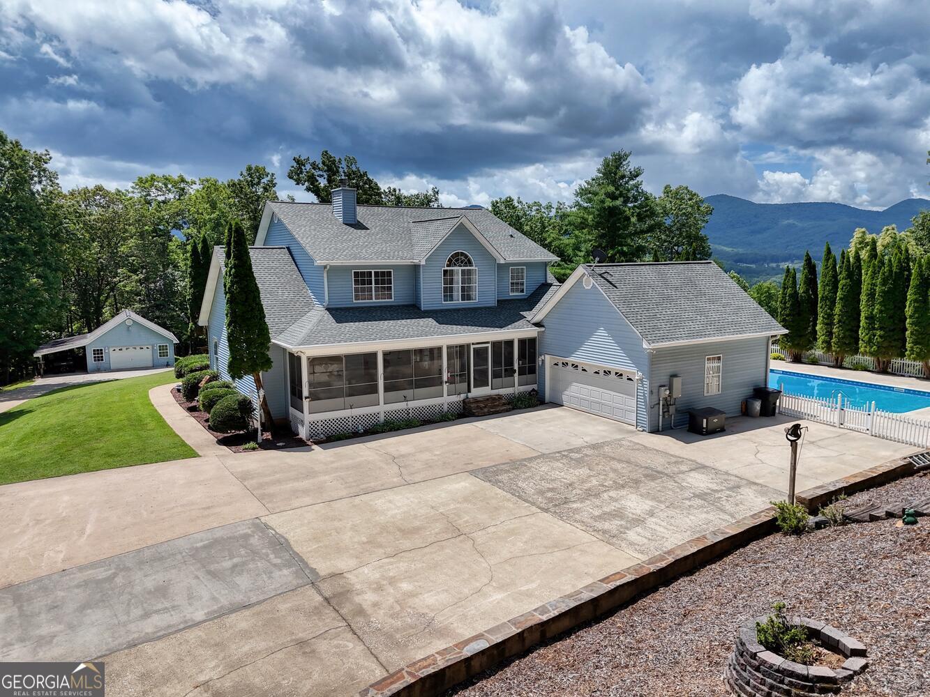 Timeless Cape Cod Retreat, 30+ Acres with Guest Cottage, Saltwater Pool & Mountain Views. Welcome to your dream mountain escape! This classic home is just minutes from town & near one of the area's most popular wineries. 4 spacious bedrooms, 2 full bathrooms, 2 half baths, and an additional 1 bedroom guest cottage, this property offers exceptional space, comfort, & opportunity for both family living & income potential. The main home greets you w/timeless charm, featuring a wraparound porch, mountain views, & nine-foot ceilings throughout. Step inside to a warm & inviting farmhouse kitchen with an oversized island, abundant cabinetry, & a sun filled breakfast room. The adjoining formal dining room comfortably seats 8 or more, perfect for holiday gatherings. The large living room features a gas log fireplace w/rock surround, built-ins & a nearby office/formal living area. The main level master suite is a peaceful retreat with a luxurious on-suite bath featuring a soaking claw foot tub, step-in shower, double sinks, a stained-glass window, & a massive walk-in closet. Upstairs, you'll find 3 generous bedrooms, a full bath, linen closet, & a charming living area ideal for kids, guests, or quiet reading. Downstairs, the partially finished basement includes a large living room with a half bath that's stubbed for a shower, plus an expansive storage area & double doors leading to the outdoors. Enjoy Summer time entertaining in the gorgeous saltwater pool surrounded by lush evergreens, a tiki bar, & a gazebo on the hill. Watch the wildlife roam and take in breathtaking sunsets from the west side of the property. The one bedroom cottage is ideal as a mother-in-law suite or rental income. It features a half bath (expandable to full), its own septic system, & room for a full kitchen addition. Whole-house generator & Newer roof. This is a rare opportunity to own a private estate that combines timeless style & natural beauty. Your mountain dream begins here!