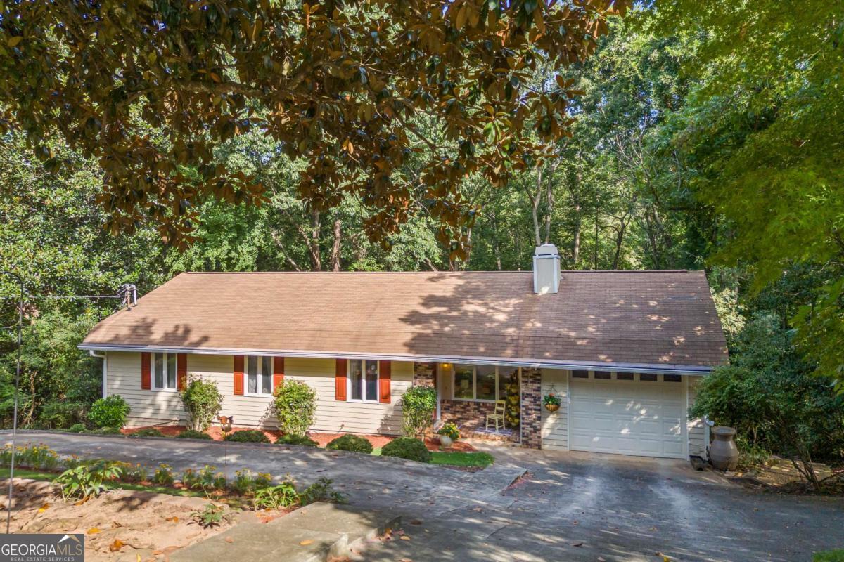 Nestled among the trees, this beautiful 4-bedroom, 3-bath home offers both privacy and character on a spacious 0.55-acre lot with no HOA. The main level features 3 bedrooms and 2 baths, along with bright sun-filled windows that fill the living spaces with natural light. The finished basement provides a fantastic opportunity for a private in-law suite or teen suite, complete with a full kitchen, 1 bedroom, and 1 bath. With 1,596 sq. ft. of living space, this home offers room to grow and enjoy. Whether you're relaxing on the property surrounded by nature or taking advantage of the basement's separate living quarters, this home is full of possibilities.