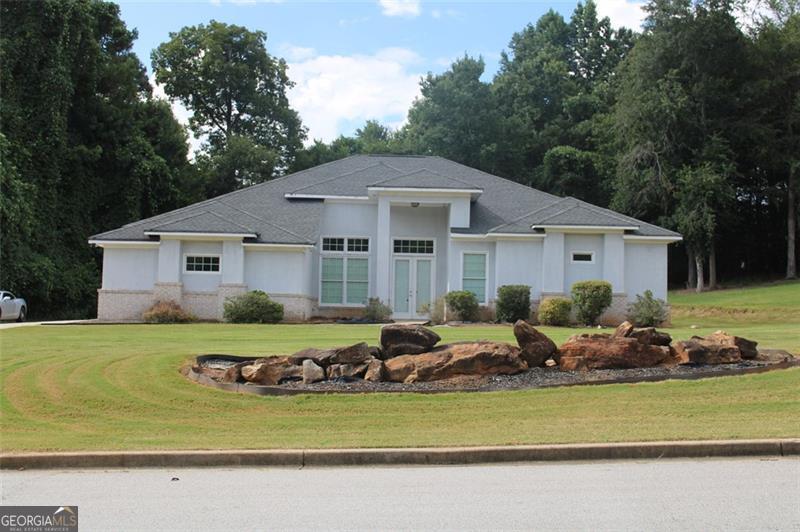 Welcome to this generously sized 4-bedroom, 2.5-bathroom ranch nestled in one of Stockbridge's most desirable HOA neighborhoods offering swim, tennis, and a vibrant sense of community. Positioned on a single level with soaring ceilings and elegant coffered details, this home delivers the space and layout you've been searching for. Step inside to discover an open-concept kitchen with an eat-in breakfast area, a formal dining room ideal for hosting, and a cozy family room featuring a warm fireplace. The expansive owner's suite is a true retreat-complete with dual closets, a garden tub, and a separate shower for added comfort. Outside, enjoy a spacious backyard perfect for entertaining, plus a two-car garage for everyday convenience. Though the property is being sold as-is and invites a bit of TLC, it presents a rare opportunity to renovate and transform it into a modern showstopper tailored to your taste. Whether you're a first-time buyer, investor, or looking for one level living, this is your chance to create something special in a sought-after neighborhood.