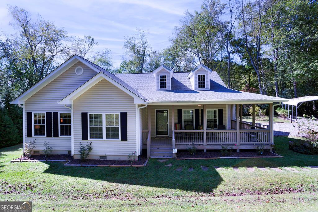 Experience the perfect blend of comfort & style in this meticulously maintained home located just a short drive from downtown Hayesville, NC. Nestled in proximity to local attractions, including a public boat facility & the charming Mountain Harbour Golf Course, this residence is designed for those who appreciate both convenience & leisure. As you step inside, you'll be greeted by an expansive open-concept living space characterized by its stunning rock wood-burning fireplace & soaring cathedral ceilings. The inviting atmosphere is perfect for hosting gatherings or enjoying quiet family evenings. Complementing this space are the thoughtfully designed 9ft ceilings that create an airy & spacious environment throughout the home. The heart of this residence is its well-appointed kitchen. Custom cabinets offer ample storage, while luxurious granite countertops provide both beauty & functionality. Equipped w/ all the essential appliances, this kitchen is a haven for any culinary enthusiast. The adjoining formal dining room is perfect for entertaining guests, while a cozy breakfast nook provides a more casual setting for everyday meals. Retreat to the master suite, your personal sanctuary featuring a generous walk-in closet, a luxurious soaker tub, & a walk-in shower. This space is designed with comfort & relaxation in mind, offering a peaceful haven after a long day. Additionally, the home includes 2 more bedrooms, w/ one currently serving as an office, presenting endless possibilities for customization to meet your specific needs. Outdoor living is a breeze with 2 covered porches that beckon you to unwind while taking in the fresh mountain air & watching the abundant wildlife. These spaces are ideal for savoring morning coffees or hosting intimate outdoor dining.