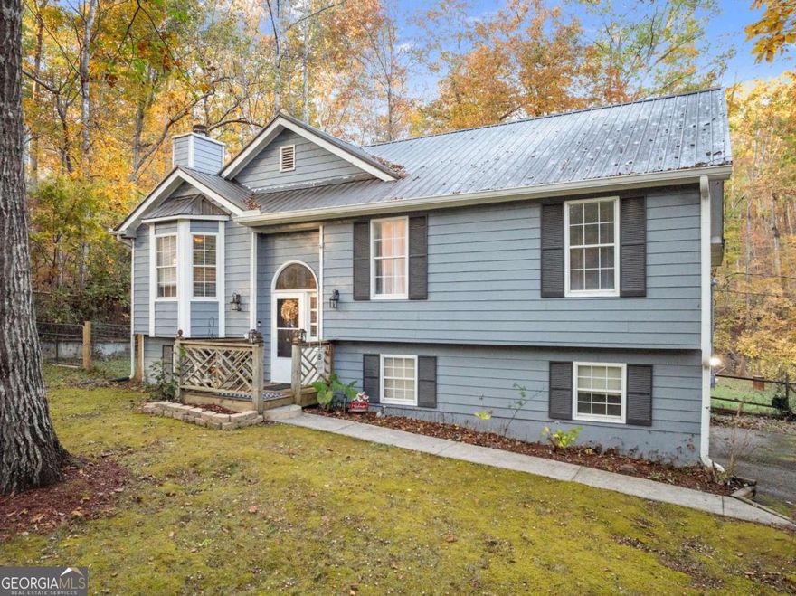 Sellers motivated, bring all offers!  NO HOA, privacy privacy privacy!  This huge 1.56-acre lot with a creek, fenced back yard and surrounded by hardwoods.  Split foyer, 3/2 with mostly bamboo/ceramic tile and hardwood flooring, leaving only one small room with carpet. Newer HVAC, hot water heater and metal roof!   There is a partially finished basement with a full bath (newer construction), a 2-car garage with a workbench, auto garage openers, outdoor kitchen will flatop, gas grill and sink with hot/cold water and refrigerator.