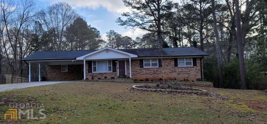 **CHECK THE COMPS---THIS IS A DEAL!!!*** Updated, decorated and sparkling clean. Updated kitchen with granite counter tops, white cabinets, glass tile backsplash, stainless fridge & gas range. Breakfast area is large enough for a full-size dining table currently has a separate sitting area. Luxury Vinyl throughout kitchen, dining area, laundry and mudroom. Formal living room with paneled walls. Family room has a chair rail, brick accent wall, exposed beam ceilings and dual ceiling fans. Fireplace has an extended hearth that is deep enough for additional seating. Modern lighting throughout. Site-stained hardwood floors in main floor bedrooms and hallway. All bathrooms have updated vanities, toilets and light fixtures. DAYLIGHT BASEMENT has a bedroom with new carpet & paint, a full bathroom, unfinished storage area with additional laundry hook-ups, large flex space (currently used as a gym), small storage nook and an additional room that could be used for a media room, office, playroom, studio or workshop. Framed concrete patio is private with a built-in outdoor grill. Lot is 325' deep with rolling grounds and NO TREES! You can actually use all of this land with no clearing needed! Two-bay utility building ready for a garage, workshop or whatever you can imagine! Long driveway with paved access to backyard. Garden accent block wall, mulch, shrubs and black gutters give it a unique curb appeal.