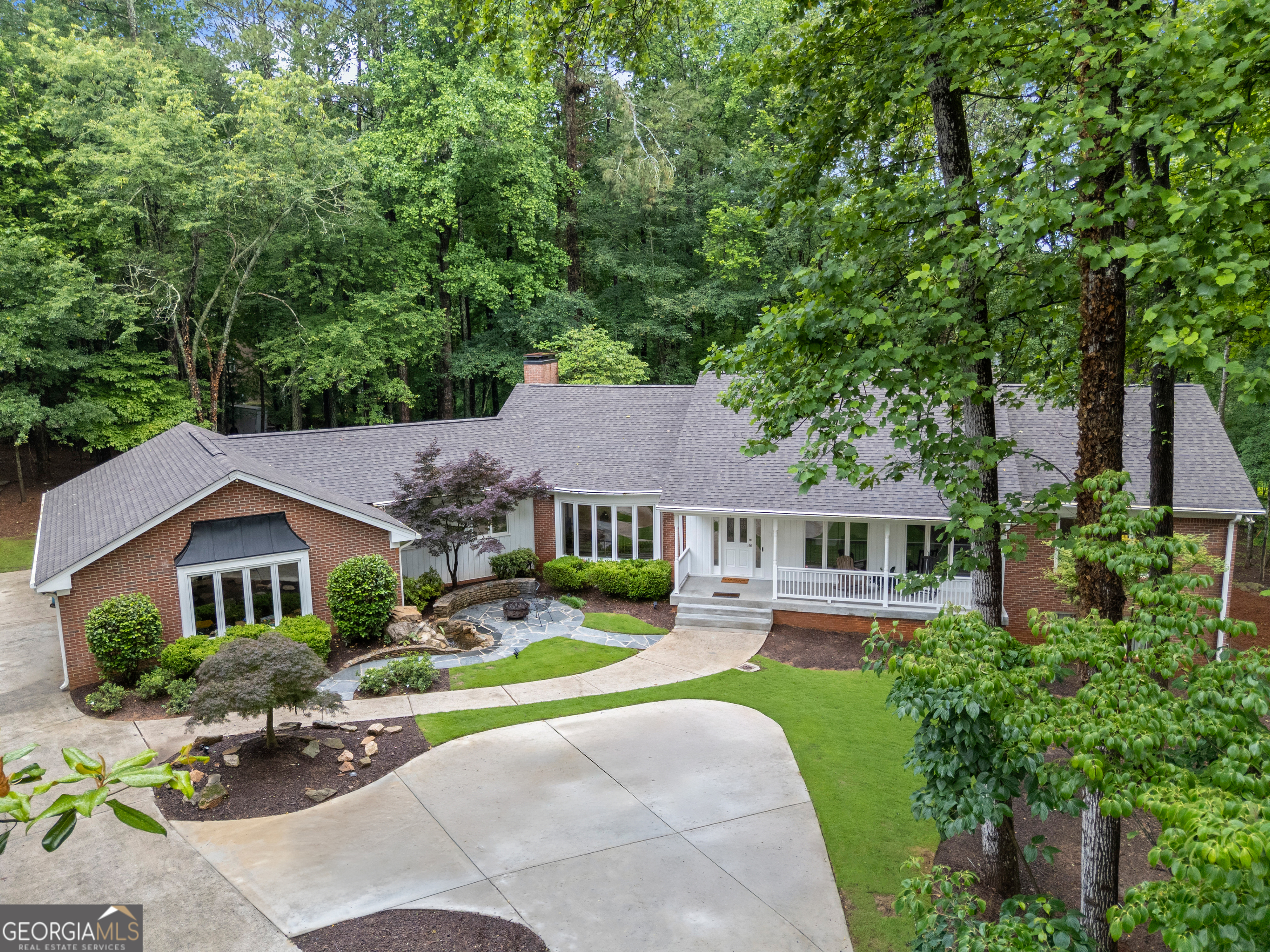 Welcome to this beautifully maintained ranch-style home nestled on a full acre, offering the perfect blend of comfort, space, and modern updates. This expansive property features 5 full bathrooms and a fully finished basement complete with a second full kitchen-ideal for entertaining or multigenerational living. Inside, you'll find a bright and airy open-concept layout that seamlessly connects the living, dining, and kitchen areas, all bathed in natural light from large windows. The updated kitchen showcases modern appliances, sleek countertops, and ample storage, while the renovated master bathroom provides a luxurious, spa-like retreat. Step outside to enjoy the large cobble patio-perfect for outdoor dining, relaxing, or hosting gatherings-all surrounded by the privacy and space of your one-acre lot. With plenty of room to garden, play, or expand, this home offers the lifestyle you've been looking for. All of this in the desired Johns Creek high school district.