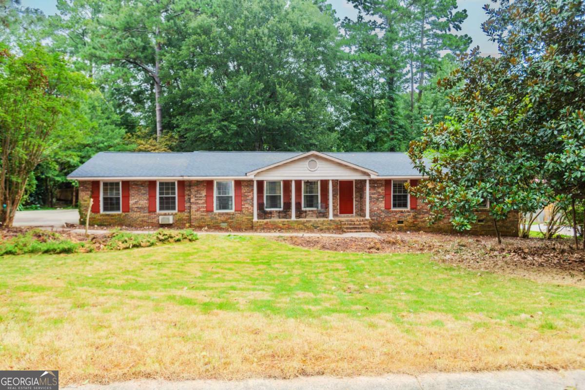 **RARE OPPORTUNITY in the Heart of Athens!** Unlock the full potential of this stately brick home, perfectly situated just 4 miles from the University of Georgia campus. Nestled on a private, wooded **half-acre lot**, this hidden gem offers peace, privacy, and endless possibilities to create your dream home. Step onto the welcoming front porch or enjoy your morning coffee from **not one, but two screened-in porches**-one just off the family room and the other off the oversized primary suite. Inside, the spacious main level boasts an **open-concept kitchen and dining area**, ideal for entertaining, along with a formal living room and a cozy family room complete with a charming fireplace. You'll find four generous bedrooms and three full bathrooms, including a **massive primary suite** featuring a sitting room or sunroom, a huge walk-in closet, and a spacious ensuite bath. **Brand New Roof Just Installed!** With great bones, classic curb appeal, and unbeatable location, this diamond in the rough is ready for your creative vision. Don't miss the chance to transform this home into a true showstopper in one of Athens' most desirable locations.