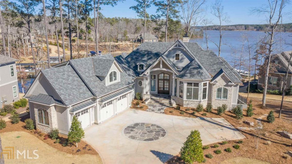 LUXURIOUS NEWLY CONSTRUCTED LAKEFRONT HOME in the Horseshoe Bend section of REYNOLDS LAKE OCONEE with impressive lake views of beautiful Lake Oconee. Enjoy watching the sunrise from this impeccable 5 bedroom, 5 bath home with too many upgraded features to list all. The custom designed kitchen with a Wolf range and Subzero refrigerator is perfect for any chef and offers double islands and a bar area with suspended walnut shelving. White oak flooring and ceiling areas, custom designed cabinets, closets, trim, beams and railing as well as quartz and marble countertops/backsplash, heated master bath flooring and Pella casement windows are just a few of the assets of this home as well as a climate controlled wine cellar, fire pit area, (4) outdoor living areas including a large screened porch and a max dock. Seller is making a club membership available.