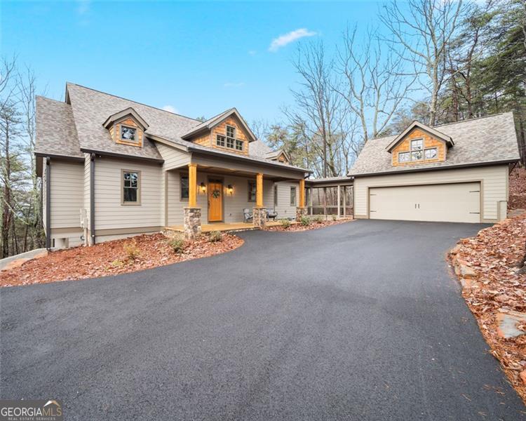 Introducing "A Walk in the Woods" - Welcome to your dream mountain retreat! Nestled in the picturesque community of Big Canoe, this newly constructed custom mountain home offers the perfect blend of luxury and tranquility. With 3 bedrooms, 3.5 baths, and 2,586 square feet of meticulously designed living space, this 2-level home is a haven for those seeking refuge in the mountains. As you approach the property, you'll be greeted by a level driveway leading to an oversized 2-car garage. The exterior showcases the beauty of stacked stone, cedar shakes, and a rocking chair porch adding to the rustic charm of the home. Step inside, you'll be captivated by the large windows that draw your eye to the seasonal mountain view. With a "vista prune" you'll enjoy a year-round view; the choice is yours. The abundance of windows throughout the home floods the space with natural light, creating a warm and inviting atmosphere. Beams line the cathedral ceiling, and a stacked stone fireplace graces the center of the living area, perfect for cozy evenings by the fire as you take in the breathtaking scenery. The gourmet kitchen features Cambria Quartz counter tops, upgraded appliances, and a spacious layout that opens seamlessly to the dining and living areas allowing for easy entertaining and family gatherings, creating a sense of togetherness in this mountain sanctuary. Notice the gorgeous plank flooring, adding a touch of sophistication to the rustic charm of the home. The master suite, located on the main level, is a true retreat, offering a private oasis with an ensuite bath and French doors that access the expansive 3-seasons porch. Two additional bedrooms provide comfort and convenience for family and guests, each thoughtfully designed with their own baths. The terrace level offers casual living, an unfinished area that could be turned into a 4th bedroom, game room or an office. There is also ample storage in the mechanical room. This mountain home is not only designed for comfort but also practicality. The property is equipped with a "Pestban" system, is prewired for a hot tub and a generator, is equipped w/ a Generac Switch, offering convenience and preparedness for any season. Whether you're enjoying the view from the deck, relaxing by the fireplace, or cooking in the gourmet kitchen, this property is designed to elevate your mountain living experience.