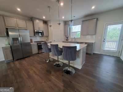 For Lease or Lease Purchase. Amazing Opportunity to Lease a 2022 Luxurious, Like New, Three Story Townhome at Brookside Lake Manor. Desirable Open Floorplan with Two Car Garage. Private Back Deck to Enjoy the Outdoors with Wooded View. The Main Living Level is Bright and Open with Gorgeous Kitchen with Large Island, Tall Grey Modern Cabinets, Top of the Line Quartz Countertops and Backsplash which overlooks the Dining Area and Great Room with Fireplace. New Sleek Stainless Steel Appliances including Side-by-Side Refrigerator. Fantastic for Entertaining and Everyday Living. Wrought Iron Spindles and Wood Stair Treads. Luxury Plank Floors. The Upper Level of this Amazing Home has the Master Suite with a Stunning Upgraded Bathroom featuring a Large Shower, Large Tile, Double Sink Vanities and Generous Sized Walk-in-Closet. Upper Level also Hosts a Secondary Bedroom with Private Bathroom. Additional Bedroom or Office on the Terrace Level with Full Bathroom Offers Plenty of Space for Everyone. Spacious Nice Community Pool and walking trail. Easy Access to I-285, Airport, Downtown. Close to Shopping and Restaurants. Washer/Dryer and Lawn Maintenance is Included. Nice Freshly painted and new flooring. Great Community. Please Call for a viewing today!