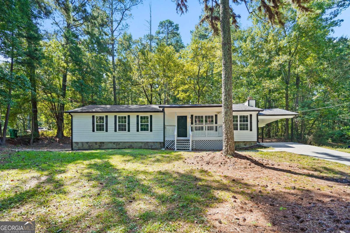 Don't miss this great opportunity in Lithonia! Beautifully updated 3BR/2BA ranch on a spacious lot. Features an open space concept with a kitchen that boasts granite countertops, brand-new appliances, fresh interior paint, new cabinets, new windows throughout, new carpet in the bedrooms, and modern lighting features. Great for first-time homebuyers or as a second home. Conveniently located near schools, shopping, and major highways