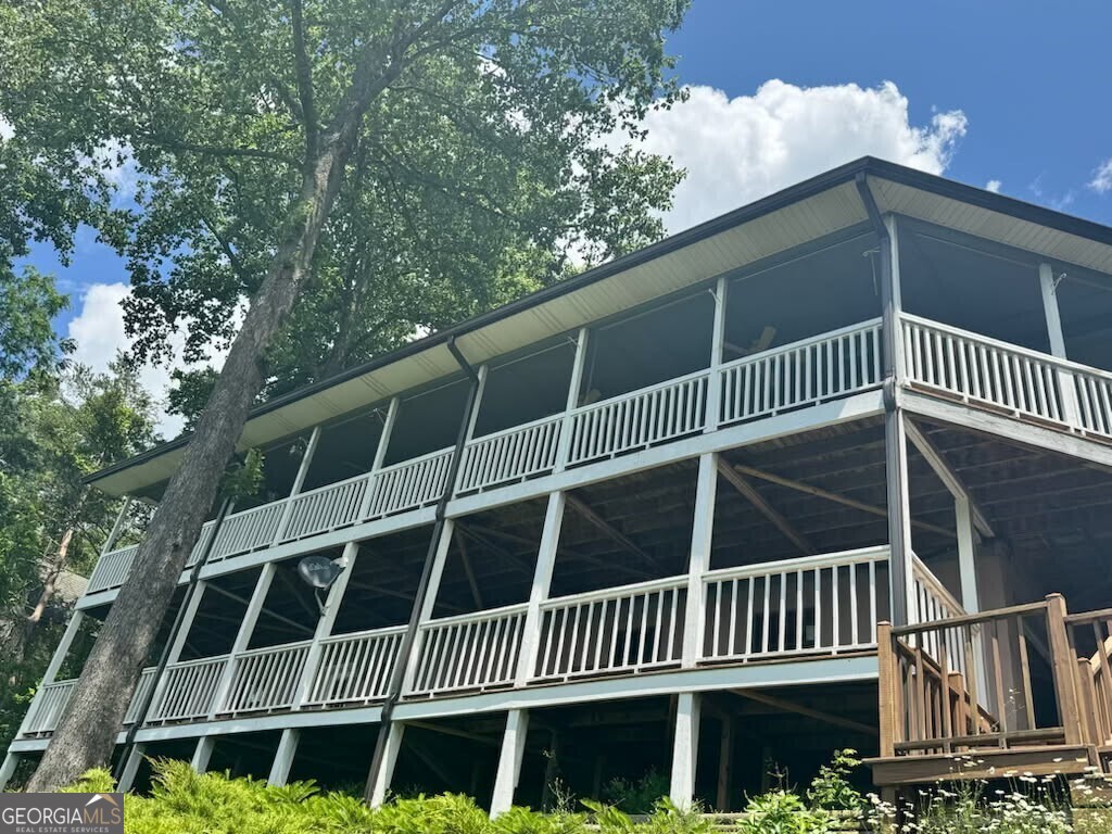Breathtaking Mountain and Lake Views from This Charming Hayesville Home! Perched in a prime location just minutes from Hayesville and Hiawassee, this home offers sweeping long-range views of both the mountains and Lake Chatuge-perfectly framed by every window and deck. Whether you're looking for a peaceful escape or a homebase, this property delivers it all! Step inside to an open-concept main floor that seamlessly blends comfort and style. The updated kitchen boasts stainless steel appliances, granite countertops, and a functional layout ideal for cooking and gathering. The spacious living and dining areas feature panoramic views and a cozy wood-burning fireplace, perfect for cooler mountain evenings. Sliding glass doors open to expansive decks-ideal for outdoor entertaining, quiet mornings with coffee, or soaking in the breathtaking sunsets over the mountains. The generous master suite includes a large walk-in closet and a private bath, offering a peaceful sanctuary at the end of the day. Downstairs, the lower-level living area is the perfect flex space for a game room or media room with direct access to another large view deck. Additional sleeping quarters and an updated full bath provide comfort and privacy. The attached two-car garage includes a workshop area and ample parking space for guests or recreational vehicles. This home is being sold fully furnished and recently upgraded including: new Atlas Pristine Architectural roof, new gutters, new HVAC system, new whole-house water filtration system, new tankless water heater, fresh paint, updated lighting, ceiling fans and fixtures, and custom shelving in closets. Enjoy the convenience of being close to shopping, dining, and a wealth of outdoor recreation options-from boating and hiking to festivals and local wineries. This home is the perfect blend of mountain charm and modern comfort. Don't miss this opportunity to own your own piece of mountain paradise!