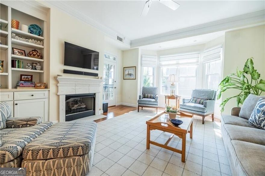 Live in the heart of Midtown Atlanta at the sophisticated Dakota condominiums. This spacious 1/1 blends classic charm with updated luxury. The large floorplan offers the feel of a home rather than a condo with an open concept layout centered around a cozy gas-log fireplace. The updated kitchen features high-end finishes including Silestone counters, Craftmade custom cabinets with slow close drawers and a stainless steel appliance package. Natural light floods the home, highlighting the beautiful chestnut floors that extend throughout the living and dining areas. Retreat to the oversized primary bedroom suite, which includes a spa like frameless walk-in shower, dual vanity, sitting area and large walk-in closet with Elfa custom storage system. The owners suite is a true sanctuary and features a tray ceiling, custom lighting and access to your private balcony. The Dakota offers residents a large rooftop pool with spectacular skyline views, a rooftop catering kitchen and fitness room, landscaped courtyards and controlled access parking deck. The property also comes with 2 assigned parking spaces which is extremely rare for a 1 bedroom home. Located just 3 blocks from Piedmont Park and the Atlanta Beltline other nearby attractions include the Fox Theatre, and Midtown's best restaurants and retail shopping. The property offers convenience to the MARTA rail system and easy access to interstates 75, 85 and GA 400. Welcome home!