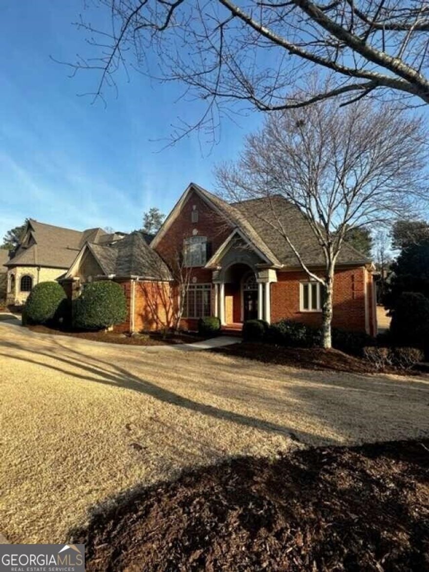 Welcome to 3083 Cambridge Hill Drive, located in Cambridge Section of Hamilton Mill and on the 7th hole of Hamilton Mill Golf Course. This 4-sided brick house offers 7 full bedrooms, 5.5 bathrooms, custom trim work throughout, and a 3-car garage with epoxy flooring. This beautiful house was updated in 2022 with master bath and kitchen updates, main level hardwood floors refinished, electrical fixtures, and painting. The main level includes owners suite with full bathroom with tub and separate shower and his/her closets. The main level also boasts a gourmet kitchen w/ double ovens, larger foyer, living room, keeping room, dining room, (2) fireplaces, (4) large custom bookshelves, desk area, laundry room, and a half bathroom. Walk up the beautiful dual staircase to the second floor which consists of 4 bedrooms, 2 with an attached full bathroom and 2 sharing a Jack n Jill bath. This house has a full daylight basement with a large entertaining area, fireplace, beautiful full bar, wine room, media room, (2) bedrooms, full upsized bathroom, and a storage/tool room. Exterior includes landscaping lighting, irrigation system, upstairs deck, upstairs covered deck, lower deck with stone patio with under deck rain protection, a large stone patio with fire pit, flat fenced yard, while all overlooking the the tee box of Hole # 7 of Hamilton Mill Golf Course. New roof installed in 2019. This home is located in a great location, has easy access to Interstate I85, Mall of Georgia, in a great school district, and all the vibrant offerings of this outstanding community. Hamilton Mill residents have access to multitude of amenities including 14 lighted tennis courts, 6 pickle ball courts, lighted basketball and volleyball courts, soccer and softball fields, two pools including a slide and play areas, playground, fitness center, a clubhouse that can be rented for special events, and a full stocked lake. Hamilton Mill Golf Course is a par-72 course co-designed by two masterful golf course designers, Fred Couples and Gene Bates.