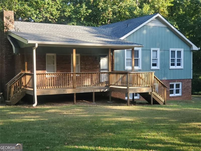 This is it, multi-level home located on a private 2.68 +/- acres. Features include: Covered rocking chair front porch, back deck, private fenced back yard, fresh interior & exterior paint, new Edwards Oak LVP flooring, great room with stone fireplace, kitchen with an abudance of cabinets, black appliance package including range, dishwasher & microwave, ceramic tile bathrooms, finished lower level with 4th bedroom & additional living room. Perfect for a home office set up. Energy effecient spray foam insulation in attic & crawl space. Clean & move in ready. Great Carrollton location. The house is near multiple shopping areas & the University of West Ga.