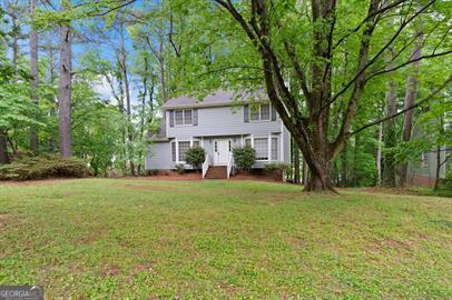 Charming 3 bedroom 2.5 bath home in sought after Marietta GA. Throughout the home you will be greeted with soft carpeting, shiny hardwood floors, a cozy fireplace, eat in kitchen, large backyard deck, as well as spacious living areas. The home also houses an unfinished basement. The home is close to Historic Marietta Square as well as so much more