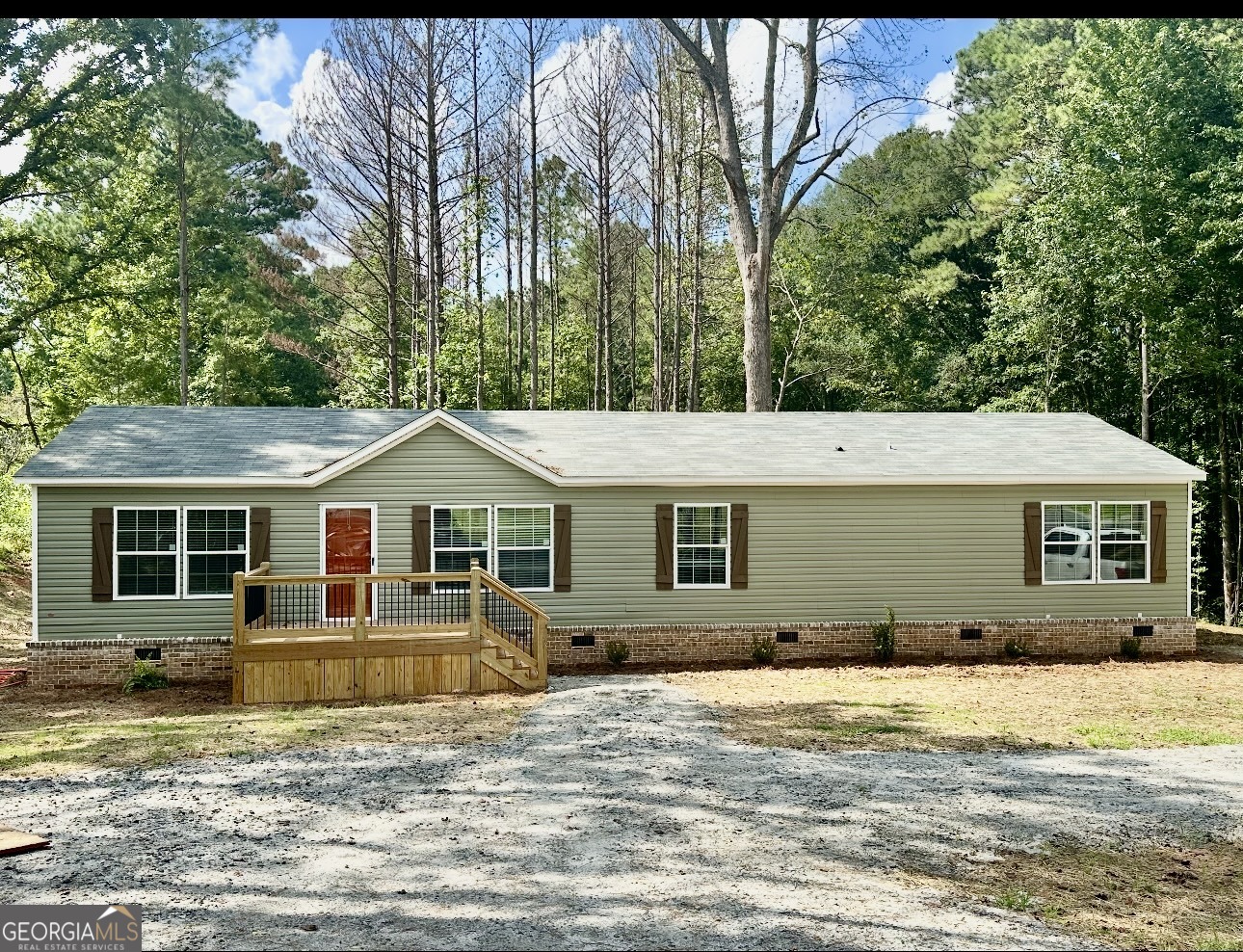 Beautiful new home located on a well kept street on a quite cul- de- sac. This sheet-rocked 3 bedroom, 2 bath home has an open floor plan and a large mud room. Each bedroom has a walk in closet and the kitchen has a very large walk in pantry. The home is wrapped in OSB, has an all-brick permanent foundation and LVP flooring throughout the home. It is wrapped in OSB with upgraded insulation. The decks and shutters are custom built. The home has energy efficient windows, stainless-steel appliances, a remote-controlled electric fireplace, a programmable thermostat, and a double sliding door off the dining area leading to the back deck. Home is conveniently located to the historical district in Newnan and close to shopping and restaurants . This home meets all FHA, VA, and Conventional Finance Standards and includes a 1-year home warranty.