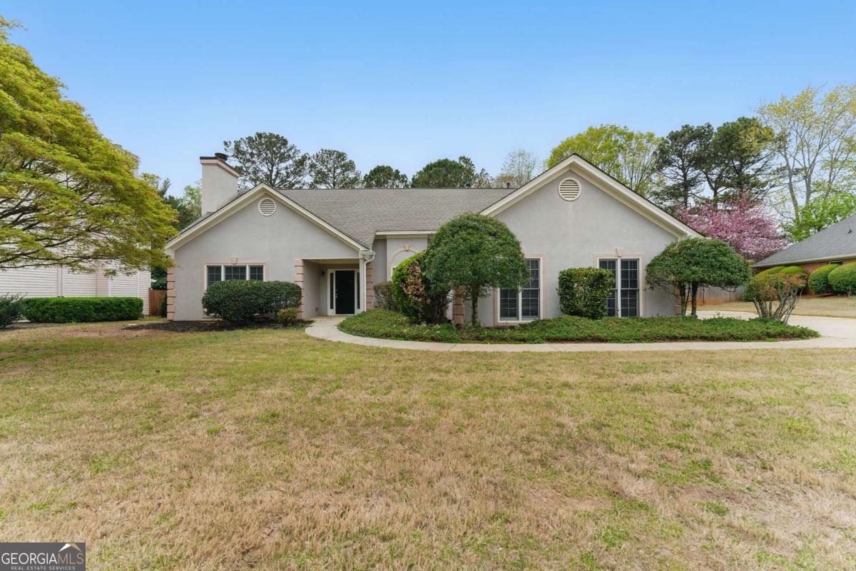Welcome to 11925 N Hickory Trce, a charming ranch-style home nestled in the desirable Alpharetta area. This inviting 3-bedroom, 2-bathroom residence offers the perfect blend of comfort and style. As you approach, you'll be greeted by a large, well-manicured front yard that provides excellent curb appeal and a warm welcome. The long driveway offers ample parking space for residents and guests alike. Step inside to discover a bright and airy interior, thanks to the abundance of natural light that floods the home. The open floor plan creates a seamless flow between living spaces, perfect for both everyday living and entertaining. The heart of the home is the eat-in kitchen, featuring modern stainless steel appliances that will delight any home chef. Adjacent to the kitchen is a separate dining room, ideal for formal meals or holiday gatherings. With three comfortable bedrooms, this home provides plenty of space for family or guests. The two well-appointed bathrooms ensure convenience and privacy for all. One of the highlights of this property is the spacious backyard, a private oasis perfect for relaxation or outdoor activities. The large deck is an ideal spot for al fresco dining, summer barbecues, or simply enjoying the fresh air. Located in the sought-after city of Alpharetta, this home offers the perfect balance of suburban tranquility and easy access to urban amenities. Don't miss this opportunity to make this lovely ranch your new home!