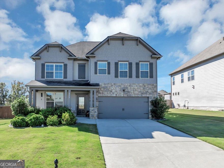 Welcome to this stunning, nearly new single-family home in the highly desirable Bramblett Grove neighborhood, located within the top-rated Forsyth County School District. This thoughtfully designed home features an open-concept floor plan perfect for modern living. The main level offers a flexible space ideal for a home office or formal sitting area, along with a guest bedroom and full bathroom, making it perfect for multi-generational living or visitors. Upstairs, you'll find a generous loft area, a large owner's suite with a walk-in closet and private bath, plus three additional bedrooms and another full bathroom. This home is filled with upgrades, including a rear sliding glass door with built-in blinds that opens to a large, fenced backyard, ideal for entertaining or relaxing. Smart home features include smart thermostats, smart light switches in the kitchen, living room, office, and stairs (with dimmable lighting in the kitchen), a smart garage door opener, and a security system complete with a smartlock and a driveway camera/floodlight. Additional highlights include soft-close cabinets and upgraded door hardware throughout the home, a five-zone irrigation system with smart controller, custom trim lighting around the entire home, low-maintenance rock pebble landscaping in the flower beds, and even a robot lawn mower for the backyard. Residents of Bramblett Grove enjoy fantastic community amenities, including a neighborhood pool, playground, and tennis courts. With its smart features, designer upgrades, and unbeatable location, this home offers a rare opportunity to enjoy both convenience and comfort in one of Cumming's most sought-after communities.