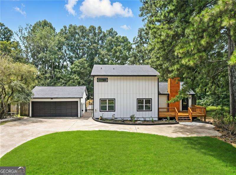 Welcome to Modern Lake-Side Living in Cumming, GA! Indulge yourself in a fully renovated 3-bed, 21/2-bath home just steps from Lake Lanier. No detail was overlooked in the transformation of this 2,274 sq-ft property. Located less than 50 feet from Young Deer Creek Park, you'll enjoy a 14-acre playground with boat ramp, courtesy dock, sandy beach and picnic areas. Launch your boat in minutes or simply relax by the water. An open floor plan integrates the brand-new kitchen and living room, featuring a peninsula with seating, cooktop, wall-oven/microwave combo and modern cabinetry. A new half-bath was added off the living area. Both full baths have been re-imagined, including a spa-style primary suite with upgraded fixtures and finishes. Energy-efficient upgrades: All windows, exterior doors and insulation have been replaced to minimize heating/cooling losses. A tankless water heater provides endless hot water and is up to 24-34 % more efficient than a traditional storage tank. New HVAC completes the package, helping keep utility bills low. Durable LVP flooring flows throughout and a redesigned staircase and fresh paint offer modern character. The formerly unfinished garage is now finished, and the property includes a newly built front entry, patio and expansive deck for indoor-outdoor living. Landscaped grounds showcase new plantings and hardscape. Situated in Forsyth County's sought-after school district with quick access to GA-400, shopping at Vickery Village and the amenities of Cumming City Center. You do NOT want to miss this one!