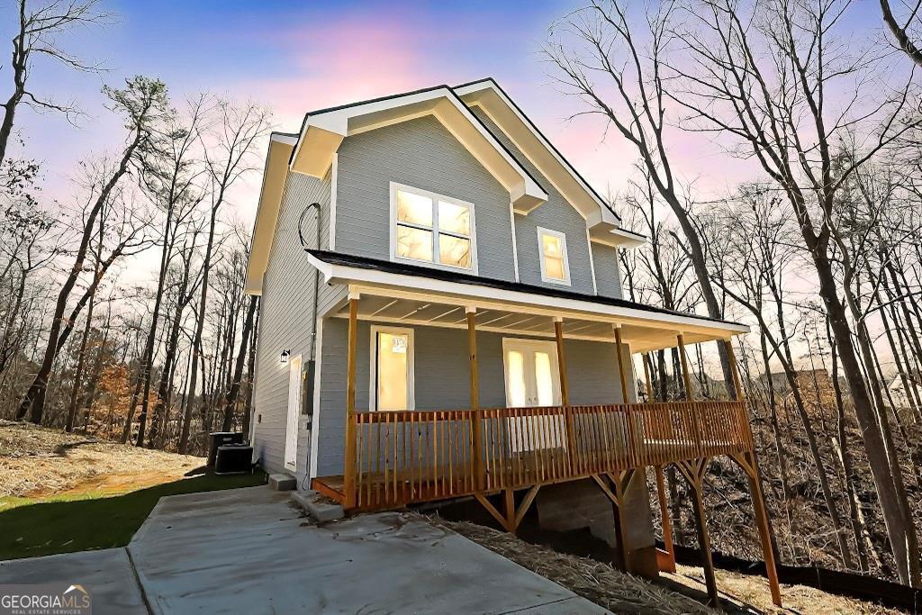 Welcome to 727 Copper Trace Way, this beautifully crafted 2024-built home, blends timeless Craftsman charm with modern convenience. Set on a generous 1-acre lot, this home offers 2 bedrooms, 3 bathrooms, and three stories of versatile living space. The main level features an inviting fireplace and a convenient guest bathroom, while outdoor spaces include a charming front porch and a spacious rear deck, perfect for relaxing or entertaining. Tucked away in a serene, no-HOA community, this property provides the privacy and freedom you've been searching for. Enjoy plenty of outdoor space for recreation or quiet reflection. Just 2 miles from top-rated Etowah High School and minutes from Downtown Woodstock, you'll have easy access to vibrant shopping, dining, and scenic parks like Olde Rope Mill Park. Quick access to major highways ensures seamless commutes to Alpharetta, Marietta, and beyond. This home is a perfect retreat with all the conveniences you need nearby-don't miss the chance to make it yours!
