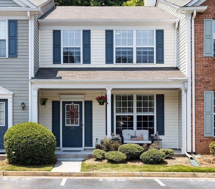 ALL SHOWINGS SUSPENDED PROPERTY LEASED. This picture perfect, completely updated, 2B/2.5BA townhome in top rated Johns Creek School District is an entertainer's dream! Perfect roommate floorplan as each bedroom has its own full bathroom. Open concept, Pergo floors throughout main and tons of natural light throughout. The large family room w/gas fireplace leads to a spacious kitchen complete with granite countertops & SS appliances. Glass sliding doors open to a fenced patio with extra storage shed. IDEAL location close to *Avalon*, 400 and shopping. Rent covers water, trash and landscaping. Pet friendly!
