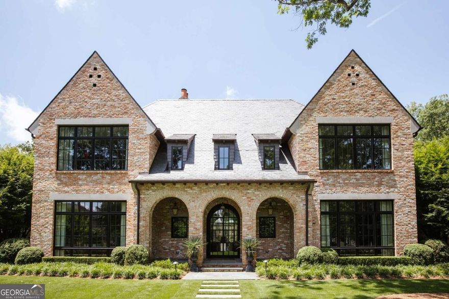 A once-in-a-lifetime opportunity to own one of Athens' most celebrated properties. This iconic, gated estate seamlessly blends historic preservation with modern luxury, offering both residential and commercial zoning. The main residence features 6 bedrooms and 5.5 bathrooms, designed for both grand entertaining and everyday living. Guests are welcomed through a stunning entrance, leading to a flowing floor plan with hand-troweled plaster walls, wide-planked hardwood floors, and refined architectural detail throughout.  The main level offers a luxurious primary suite and a private guest suite, alongside a formal dining room, elegant bar, and a showpiece kitchen that spills effortlessly into the grand living room and outdoor entertaining spaces. A scullery, mudroom, and fully tiled laundry with a dog bath add convenience. Front and back staircases connect the home's multiple living areas and create the perfect flow.  Upstairs, you'll find two guest suites with private baths, two additional bedrooms with a Jack-and-Jill bath, plus a craft room, spacious media lounge overlooking the pool, and abundant storage.    Outdoor living is the heart of this estate. The kitchen flows into the large, screened porch with fireplace and TV, opening further to a covered patio, heated pool, and spa-designed for gatherings of any size. The pool house includes a full bath and generous storage for floats and outdoor essentials, ensuring every detail is considered.    The guest house, known as the Hunnicutt House, is a treasured piece of Athens' history and winner of the 2016 Best Historically Preserved Property Award. Beautifully renovated, it includes its own two-car garage, main-level master and two additional bedrooms, a loft, upstairs guest suite with bath, and a full gym.    This estate offers a rare combination of historic significance, modern amenities, and versatile use potential-making it one of Athens' most remarkable and sought-after properties.  For additional pictures please visit www.1070milledgeave.com