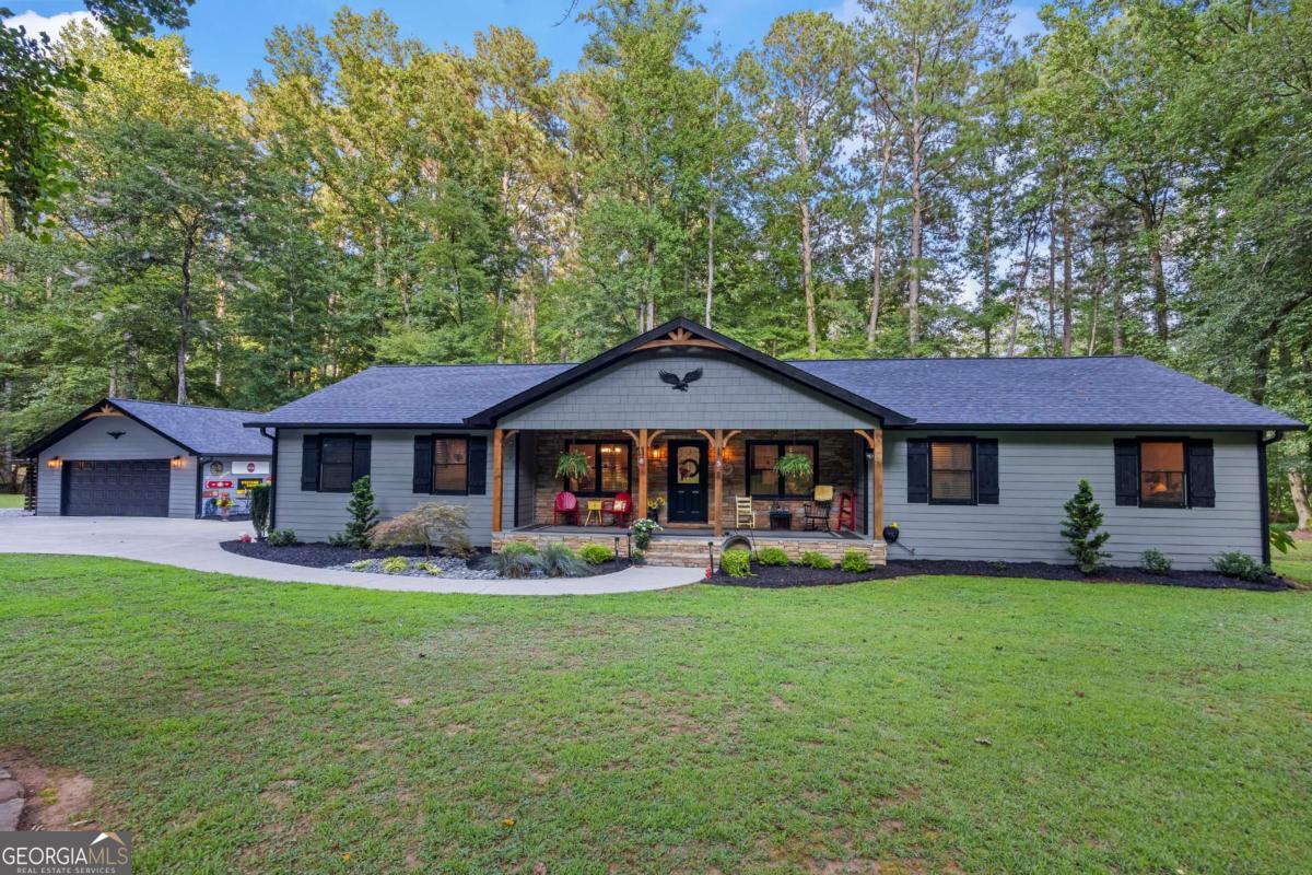 If you've been dreaming of a home on the water, this is your moment! Nestled right along the scenic banks of Pigeon Creek, this fully renovated 4-bedroom, 3-bath beauty offers the perfect mix of comfort, privacy, and natural surroundings, all just 10 minutes from downtown Dawsonville and 20 minutes to Highway 400. Outdoor lovers will be right at home here, just minutes from Amicalola Falls, a quick hop to Ellijay and Dahlonega, and surrounded by scenic hiking trails, wineries, and the famous Apple Orchards of North Georgia. Whether you're chasing waterfalls, exploring the mountains, or enjoying a weekend wine tasting, adventure is always close by. Inside, you'll find nearly 2,200 square feet of thoughtfully updated living space with brand-new LVP flooring throughout, two spacious master suites, one with private deck access overlooking the creek, the other featuring a walk-in man-cave shower and walk-in closet. This home boasts a cozy, functional layout. The kitchen retains its original charm with beautiful cabinets and countertops, offering warmth and character in the heart of the home. The hall bathroom features a gorgeous freestanding tub and top-of-the-line designer finishes that add a touch of luxury and elegance to the space. Step out onto the oversized screened-in back porch, steps from the water, perfect for sipping coffee, watching TV, relaxing with a book, or listening to the gentle sounds of the Creek. There's even a bonus room behind the two-car garage with windows overlooking the creek, ideal for a home office, gym, or additional storage, complete with private entry to both the exterior and interior of the garage. Insulated and ready for completion. Outside, the property is a showstopper. Professionally landscaped with flagstone walkways, custom lighting, and whimsical yard ornaments, all lit to perfection. Driving up at night feels like arriving at your own Private Oasis. There's even room to build a shop or in-law suite (up to 2,100 sq ft). This home is a rare find, completely renovated from the inside out, blending rustic charm with stylish upgrades and modern comfort. You will not find anything comparable. Schedule your showing right away before this beauty is gone.