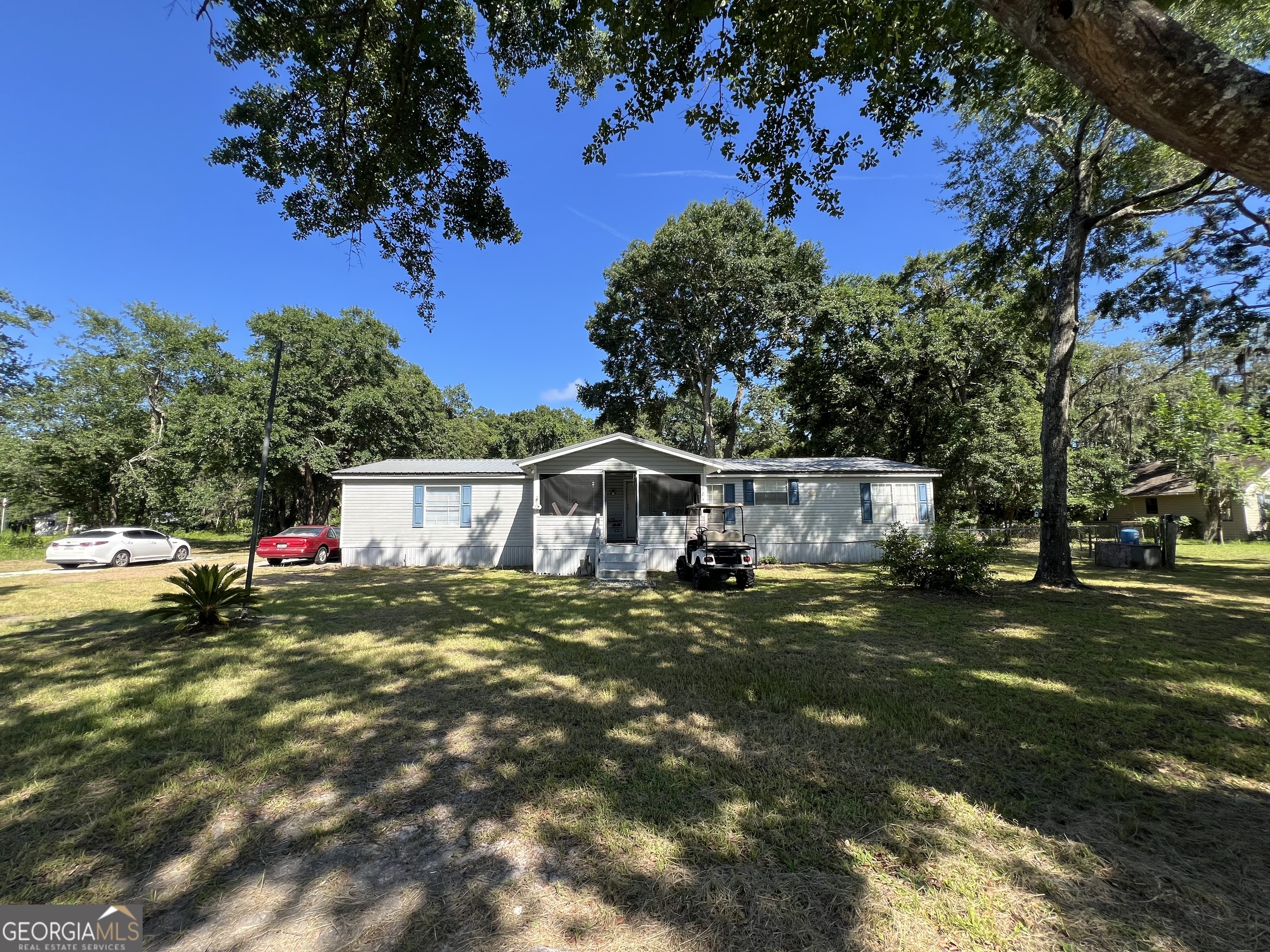 Welcome to your ideal blend of comfort and convenience! This spacious 1,960 sq ft manufactured home sits on a .7-acre lot and features a newly updated kitchen, perfect for modern living. Enjoy the outdoors with a large lean-to over a concrete slab-an excellent space for ATVs, boats, or equipment storage. Located just minutes from Crooked River State Park, you'll have endless opportunities for recreation and nature. Plus, with easy access to I-95, you're only 45 minutes from Jacksonville or Brunswick. Whether you're looking for a full-time residence or a weekend getaway, this property offers the space, updates, and location you've been looking for!