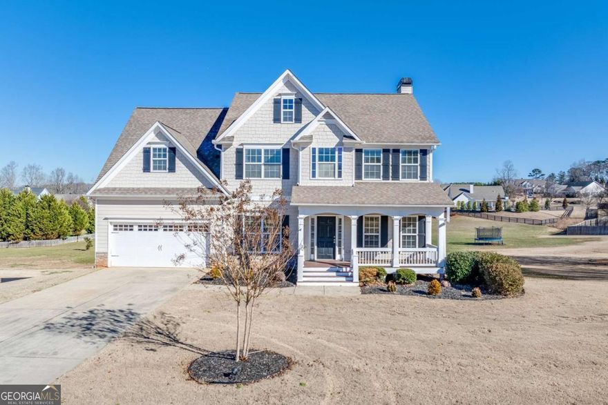**Beautiful 4-Bedroom Home on Large Lot Near New Jackson County School Campus!**  Welcome to this charming 4-bedroom, 2.5-bath two-story home located in the heart of Hoschton. Situated on a spacious lot with a large front yard and a huge backyard, this property offers plenty of room to relax, play, and entertain. The inviting covered front porch leads into a bright two-story foyer that sets the tone for the open, comfortable layout inside.    The kitchen is a chef's delight featuring granite countertops, stained cabinets, a gas cooktop, double ovens, and a stainless steel refrigerator. The adjacent family spaces provide an easy flow for everyday living and entertaining. Upstairs, you'll find large secondary bedrooms with walk-in closets and a generous owner's suite with a spa-like bath, complete with a soaking tub and dual vanities.    Enjoy peaceful mornings or evening gatherings on the screened back porch overlooking the expansive backyard. The unfinished walkout basement-already stubbed for a bath-offers endless potential for future expansion. Additional highlights include a two-car garage and a prime location less than one mile from the new Jackson County Schools campus.    This is the perfect blend of comfort, convenience, and value in a highly sought-after area!