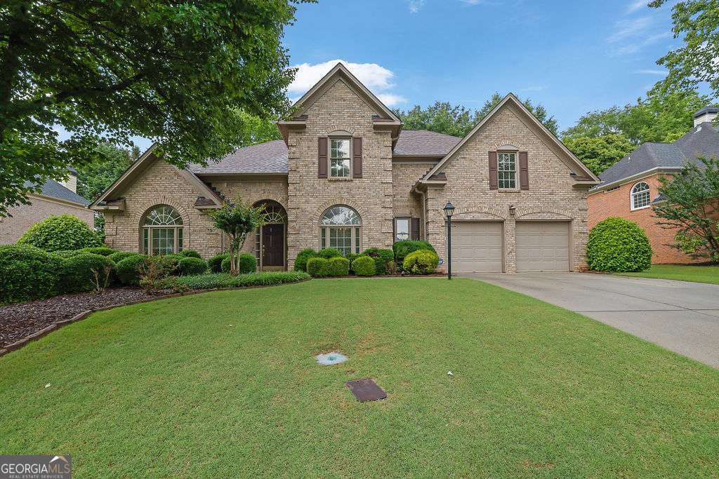 Welcome to this beautifully maintained 5-bedroom, 3 Full bathroom smart home located in the desirable Highcroft subdivision of Peachtree Corners. This 3-side brick home offers timeless style and modern convenience. Step inside to a two-story open foyer and an inviting open floor plan on the main level, featuring hardwood floors in mint condition. The newly updated in front of eat-in kitchen is a chef's delight with a double oven and a clear view into the vaulted family room complete with a cozy fireplace. A guest bedroom or office with full bath on the main level adds flexibility to the layout. Upstairs, you'll find four spacious bedrooms, including a primary suite with a fully updated bath, and an updated Jack and Jill bath connecting two of the secondary bedrooms. This smart home comes equipped with two EV chargers in the garage, an ADT security system with cameras, and a nicely landscaped front yard. With the roof and HVAC in great condition, this home is truly move-in ready. Located in a community that offers amenities including a pool and tennis courts, and conveniently close to top-rated schools, shopping, and dining, this home combines comfort, functionality, and lifestyle in one incredible package.