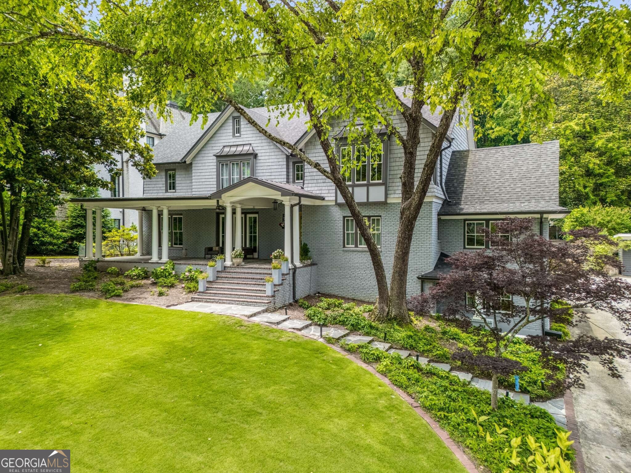 Welcome to this extraordinary, fully remodeled home in Sherwood Forest, one of Atlanta's most coveted and family-friendly neighborhoods. Thoughtfully designed and masterfully renovated, this six-bedroom, seven-and-a-half-bathroom residence offers elegant living across four spacious levels-all accessible by elevator. Every bedroom features its own ensuite bath and custom closet, with two bedrooms on the main level, three upstairs, and a private studio apartment in the finished basement-perfect for guests, in-laws, or au pair accommodations. The main level also includes a dedicated home office and an expansive kitchen that is truly the heart of the home. Outfitted with gleaming white custom cabinetry, Thermador appliances, and a one-of-a-kind scullery complete with a second sink, additional dishwasher, and wine refrigerator, the kitchen is designed for seamless entertaining and daily living. The top level features a versatile entertainment space ideal for kids, gaming, or a home theater. Two laundry rooms-one on the lower level and another upstairs-add convenience, and a custom dog nook is cleverly tucked beneath the stairs. A two-car garage, ample storage throughout, and a thoughtfully designed layout complete the interior. Step outside to experience resort-style living in your own backyard. A 500-square-foot covered patio with a fireplace, TV, and full indoor kitchen overlooks a stunning deep-water pool with spa. The lush, fenced yard includes a built-in firepit and plenty of room to play or relax. The bonus pool house is fully conditioned and includes a full shower, making it ideal as a guest retreat, gym, or studio. Set on over half an acre and located just minutes from Piedmont Park, Ansley Golf Club, Atlanta's top restaurants, retail destinations, major interstates, and public transportation, this home offers the perfect combination of luxury, comfort, and convenience.