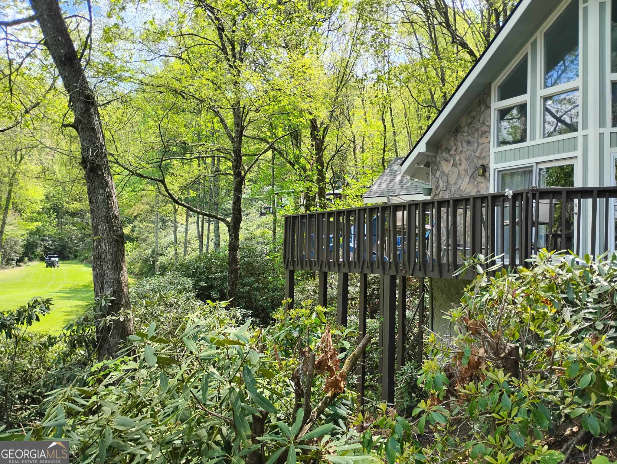 Follow the paved, winding driveway, through a Rhododendron Thicket, to this adorable Chalet, overlooking the 14th Fairway in Sky Valley, GA. This 3 Bedroom 2 Bathroom home welcomes you with a Stone Walkway. Once inside, you will find pecan floors throughout the main living area, a rock fireplace, wooden beams at the vaulted ceilings, and a spiral staircase to the Master Suite. The Living Area offers Floor to Ceiling Windows, where you can take in the views of the Beautiful Mountains and the Manicured Golf Course. On the main floor, there are 2 good-sized bedrooms, an updated Kitchen with nice appliances and Solid Surface Countertops, and a recently added full bathroom with a Walk-In Tiled shower and Double Vanities. There is a large front deck overlooking the Fairway, with plenty of space for entertaining. Off the kitchen is a Screened Porch, sitting above a small, noisy stream complete with outdoor furniture for napping, as well as a TV. This property offers all the modern conveniences plus, with almost an acre of wooded land, you have the privacy to relax in your own Mountain Oasis. This home is being offered mostly furnished with beautiful, almost brand-new furniture, excluding family heirlooms and personal items. Sky Valley Golf Club offers many levels of membership and there is no mandatory HOA required for you to join. Amenities include Golf, Pickleball, Croquet, Tennis, a Community Pool, Private Restaurant, and Exercise Facility. This community is surrounded by nature with lakes, waterfalls, and walking trails that are free to enjoy. It is only 20 minutes to Clayton, GA or Highlands, NC and within 10 minutes of Highlands Outpost for Snow Tubing & the Alpine Coaster and Highlands Aerial Park for Ziplining in Scaly Mtn, NC.
