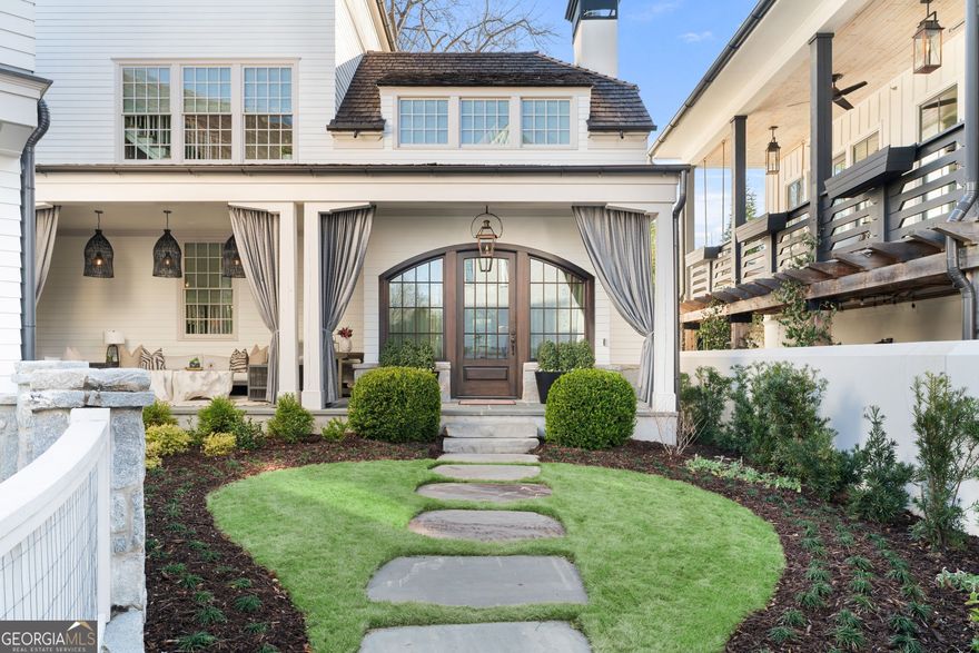 Rare Opportunity to Own Downtown Alpharetta's Most Coveted Address Nestled in the heart of Downtown Alpharetta, this stunning Hedgewood custom home in Voysey offers an extraordinary blend of luxury, convenience, and architectural excellence. As the newest home in Voysey-the only neighborhood that is part of Alpharetta City Center-this is a rare opportunity to experience the best of city living while enjoying the privacy and sophistication of a meticulously designed residence. Located directly across from Brooke Street Park and steps from the Alpha Loop to Avalon, this home offers an effortless connection to the best dining, shopping, and entertainment Alpharetta has to offer. The vibrant energy of downtown meets the tranquility of a lush, private setting, creating a lifestyle that is both elevated and refined. Step inside to discover a home where every detail has been carefully curated. Main level features soaring 11-foot ceilings and site-finished white oak flooring that set the tone for the refined elegance throughout the home. A striking floor-to-ceiling limestone fireplace serves as the focal point of the living space, while oversized windows flood the room with natural light and offer serene views of the beautifully landscaped private courtyard. Kitchen is a true work of art, blending timeless design with modern functionality. Dual wood-paneled dishwashers and a custom Venetian plaster hood with a rich wood beam accent create a sophisticated and welcoming atmosphere. Wood-paneled Sub-Zero refrigerator integrates seamlessly into the cabinetry, while the adjacent scullery prep kitchen and walk-in pantry provide both convenience and storage. Custom-designed wine and champagne room with iron refrigeration doors, vapor-sealed insulated walls, and precise climate control offers the perfect space to showcase and preserve your collection. Owner's suite is a private sanctuary, offering a separate sitting room, workout space, or office. Built-in coffee bar ensures that your mornings begin with ease and comfort. His and hers custom walk-in closets are designed to maximize storage and style. The spa-inspired owner's bath features a large soaking tub, dual vanities, and an oversized shower, creating a peaceful retreat. The upper levels reflect the same attention to detail and thoughtful design. A private guest suite on the second level along with a full-size laundry room with custom cabinetry and a farmhouse sink, add both function and character. Two additional en-suite bedrooms on the third floor provide privacy and comfort, each designed with impeccable craftsmanship and top-tier finishes. Throughout the home, thoughtful upgrades elevate both style and functionality. Custom closets have been added to all bedrooms, along with additional storage in two upstairs units and the garage. Designer lighting has been installed in every room, including the bathrooms, kitchen, sitting room, and living room, adding warmth and character to the space. A custom-built cabinet on the front porch includes a built-in refrigerator, ideal for seamless outdoor entertaining. A beautifully designed mudroom with lockers and cabinetry enhances the home's functionality, while a finished storage space behind the owner's closet maximizes organization. Even the staircase has been elevated with a custom-built furniture unit that blends both style and utility. The home is secured by a state-of-the-art 6-camera integrated alarm system and powered by tankless water heaters for energy efficiency. The oversized garage features high ceilings and convenient garage door returns, providing ample storage and easy access. This is more than just a home - it's a statement of refined living. The magic of Downtown Alpharetta's walkable lifestyle, combined with the precision and craftsmanship of this exceptional residence, creates a rare and unmatched opportunity. Don't miss your chance to own the newest and most distinguished home in Voysey - Alpharetta's most coveted address.