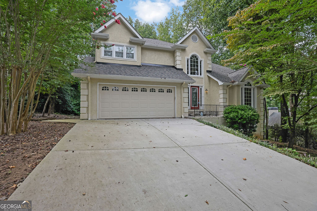 Welcome to this beautifully maintained two-story home offering 4 bedrooms, 2.5 bathrooms, and exceptional living space throughout. Step inside to a dramatic two-story foyer that opens into a large formal living and dining area-perfect for entertaining guests or enjoying quiet evenings at home. The heart of the home is the eat-in kitchen, featuring a full breakfast bar, sleek stainless steel appliances, and a clear view into the main family room. Gather around the cozy fireplace in the family room, a warm and inviting space ideal for relaxing with loved ones. Upstairs, you'll find an oversized master suite boasting a spacious en-suite bath complete with separate vanities, a whirlpool tub, a walk-in closet, and elegant finishes. Three additional bedrooms offer ample space for family, guests, or a home office. Crown molding and decorative trim throughout the home add a touch of classic charm, while the full walk-out basement provides endless potential for additional living or recreational space. Enjoy the outdoors on the large, oversized back deck-perfect for grilling, entertaining, or simply taking in the view.