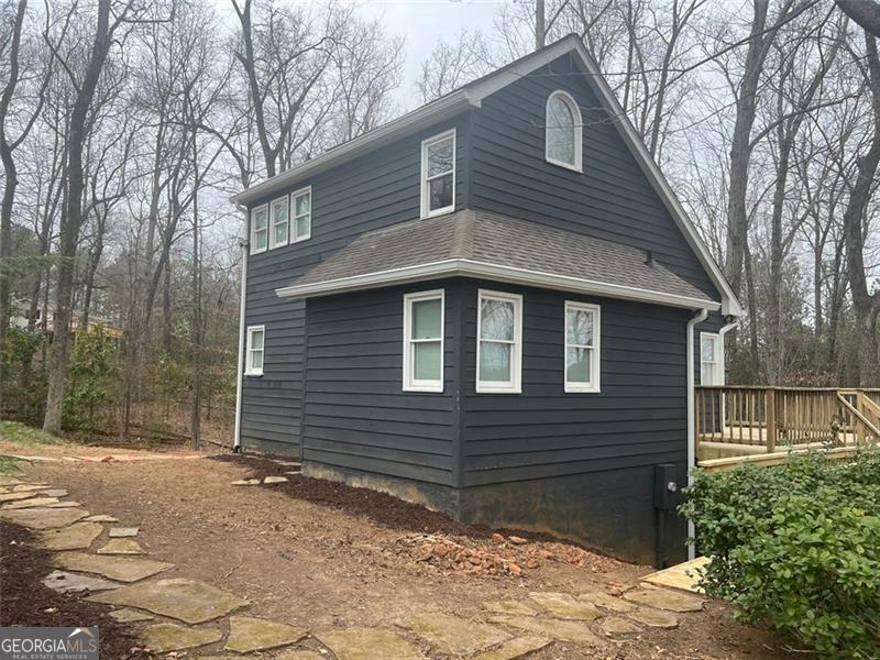 Great location mins to Halycon,Ga 400 and the greenway. Charming Cottage-Style home nestled on a serene, one-acre wooded lot, this charming 3-bedroom, 2-bath . A true hidden gem, it feels like a private retreat while still providing all the conveniences of home.The beautifully updated kitchen features top of the line applanices, while the spacious great room boasts soaring ceilings, creating a bright and inviting living space. The main level also includes a full bathroom with a stunning tiled shower. Upstairs, the loft-style primary bedroom overlooks the main floor and includes a full bath and a walk-in closet. The finished basement provides additional bedroom and storage, a cozy fireplace, and versatile flex space-ideal for a home office, guest area, or second living space. Step outside to embrace the beauty of nature from the expansive wrap-around deck. The home's peaceful and private setting, making it the perfect place to unwind and enjoy wildlife.